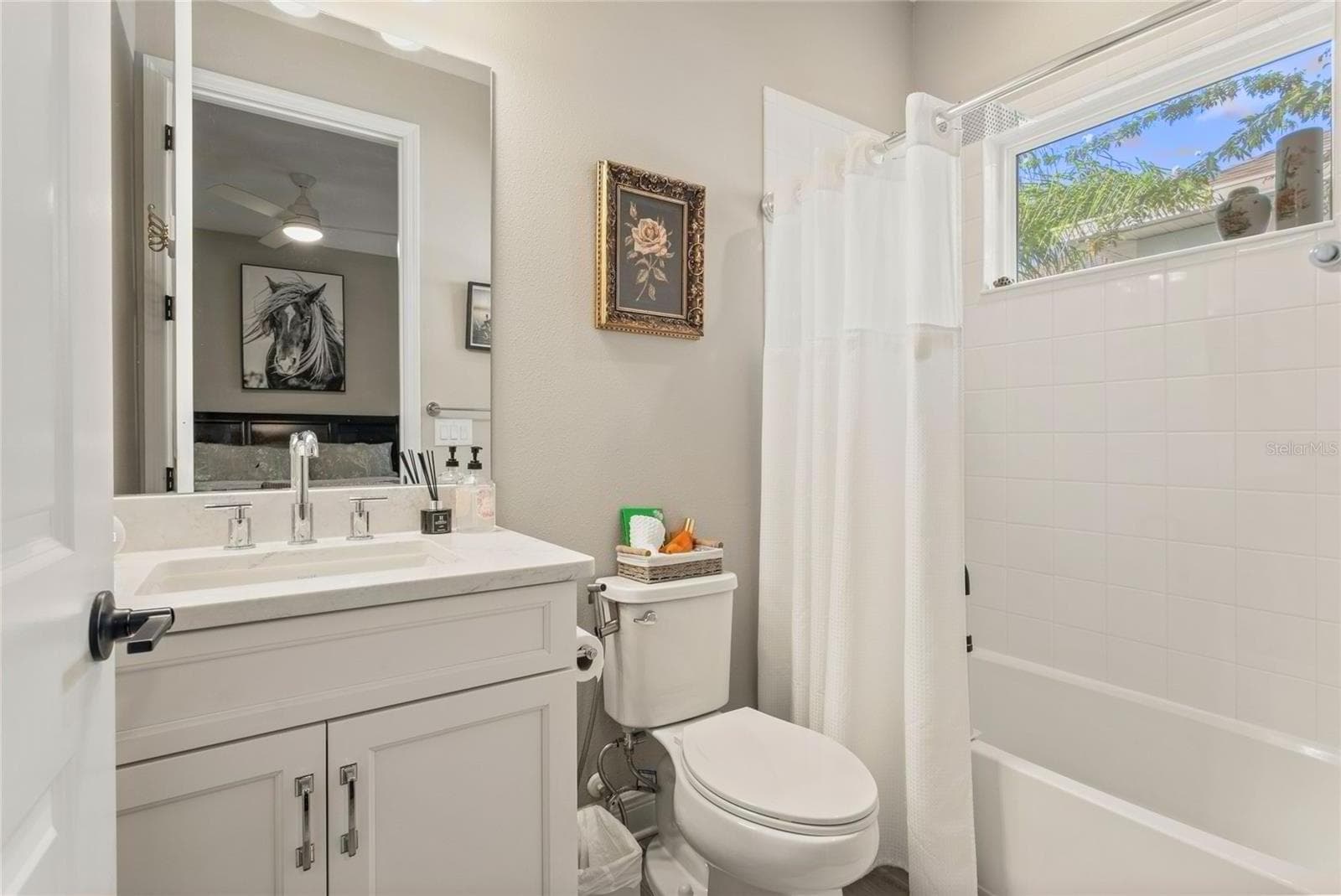 Downstairs private en-suite bathroom with modern finishes, bright natural light, and a clean, well-designed layout offering comfort and convenience. - 10625 FALLING LEAF CT, PARRISH