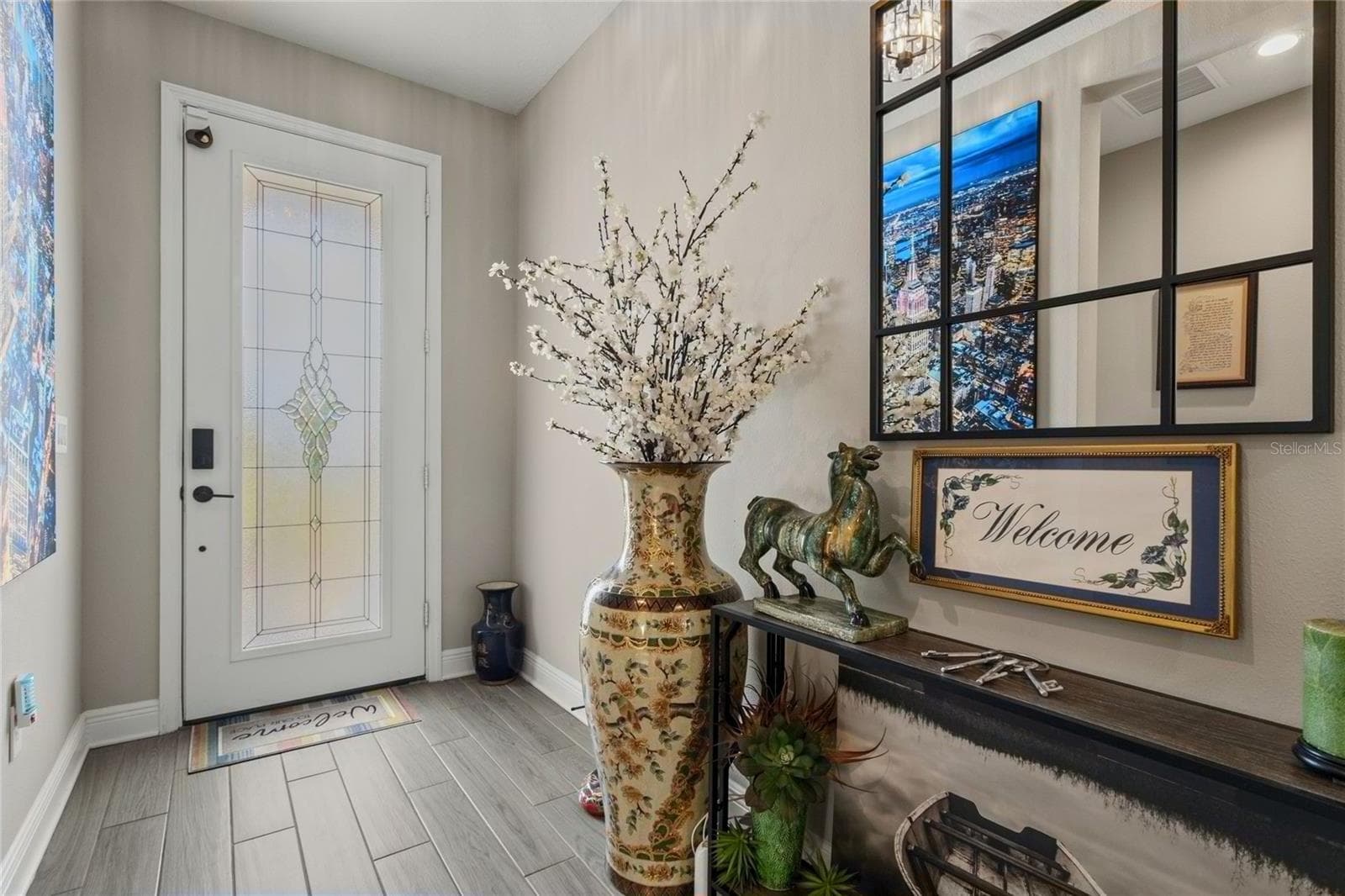 Inviting front entryway with modern finishes, an open and ample view toward the pool area, and a bright layout that creates a welcoming first impression - 10625 FALLING LEAF CT, PARRISH