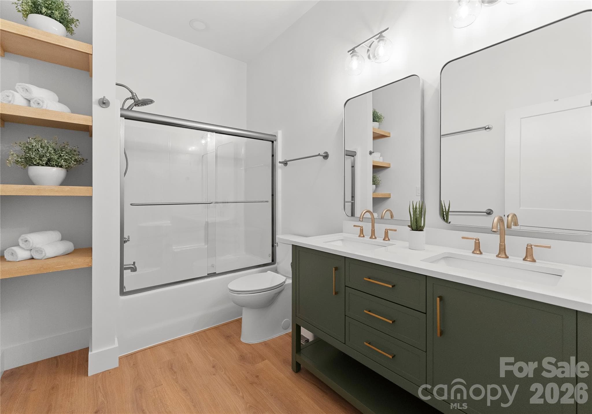 A double vanity, open shelving, and a tub-shower combination make this bathroom both polished and practical. - 143 Hideaway Lane, Mooresville