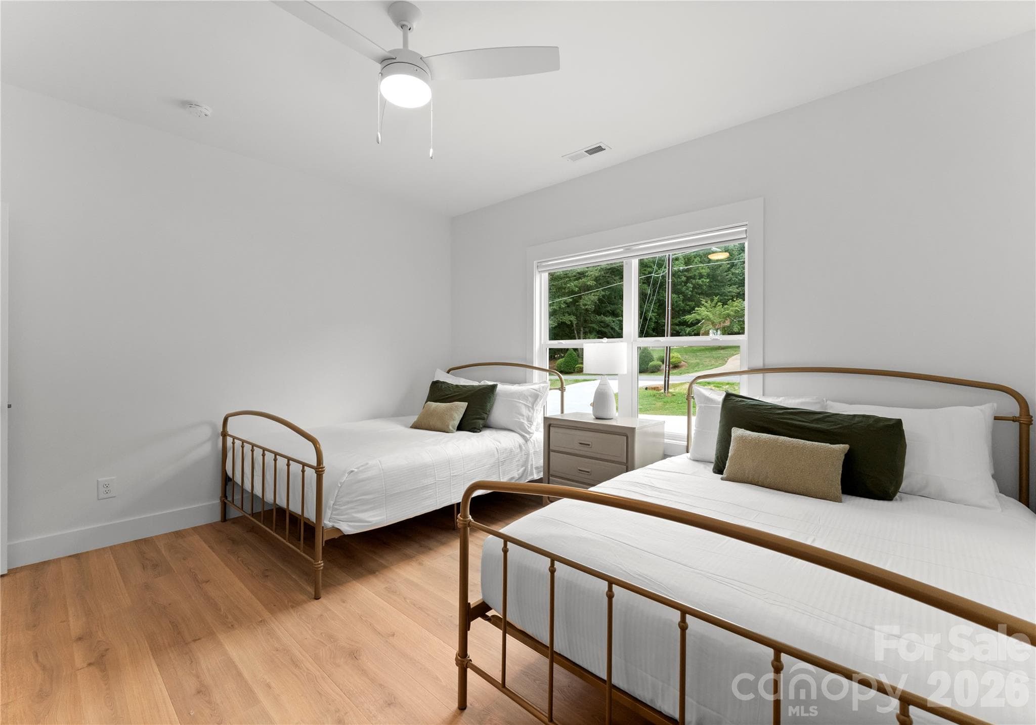 Two beds and a large window make this bedroom a comfortable retreat. - 143 Hideaway Lane, Mooresville