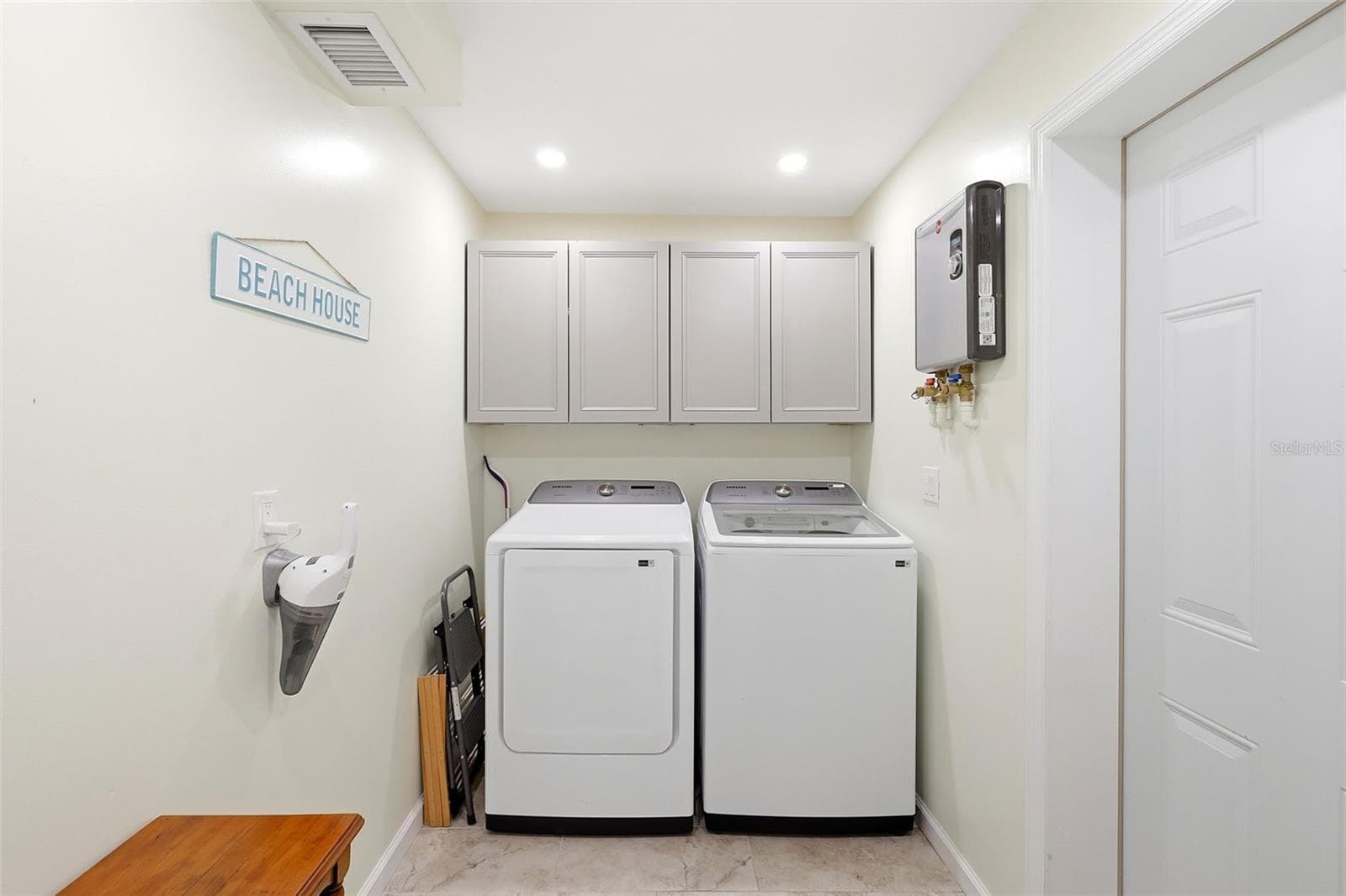 Laundry with tankless water heater - 159 LAURIE DR, ORMOND BEACH