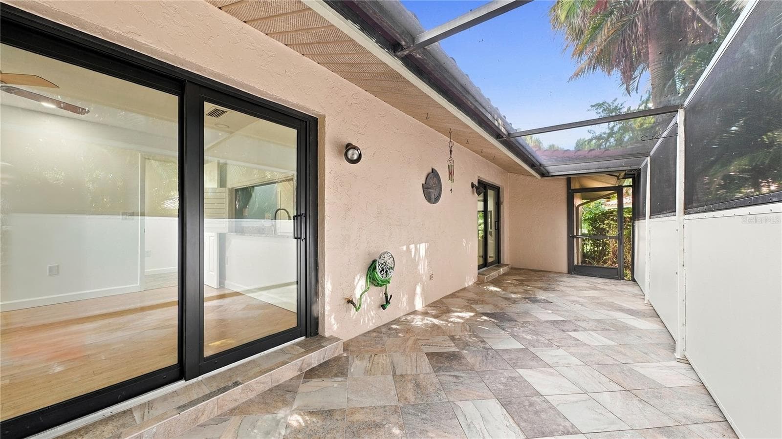 Side Screened in Porch the entire length of home. - 4802 KESTRAL PARK CIR #22, SARASOTA