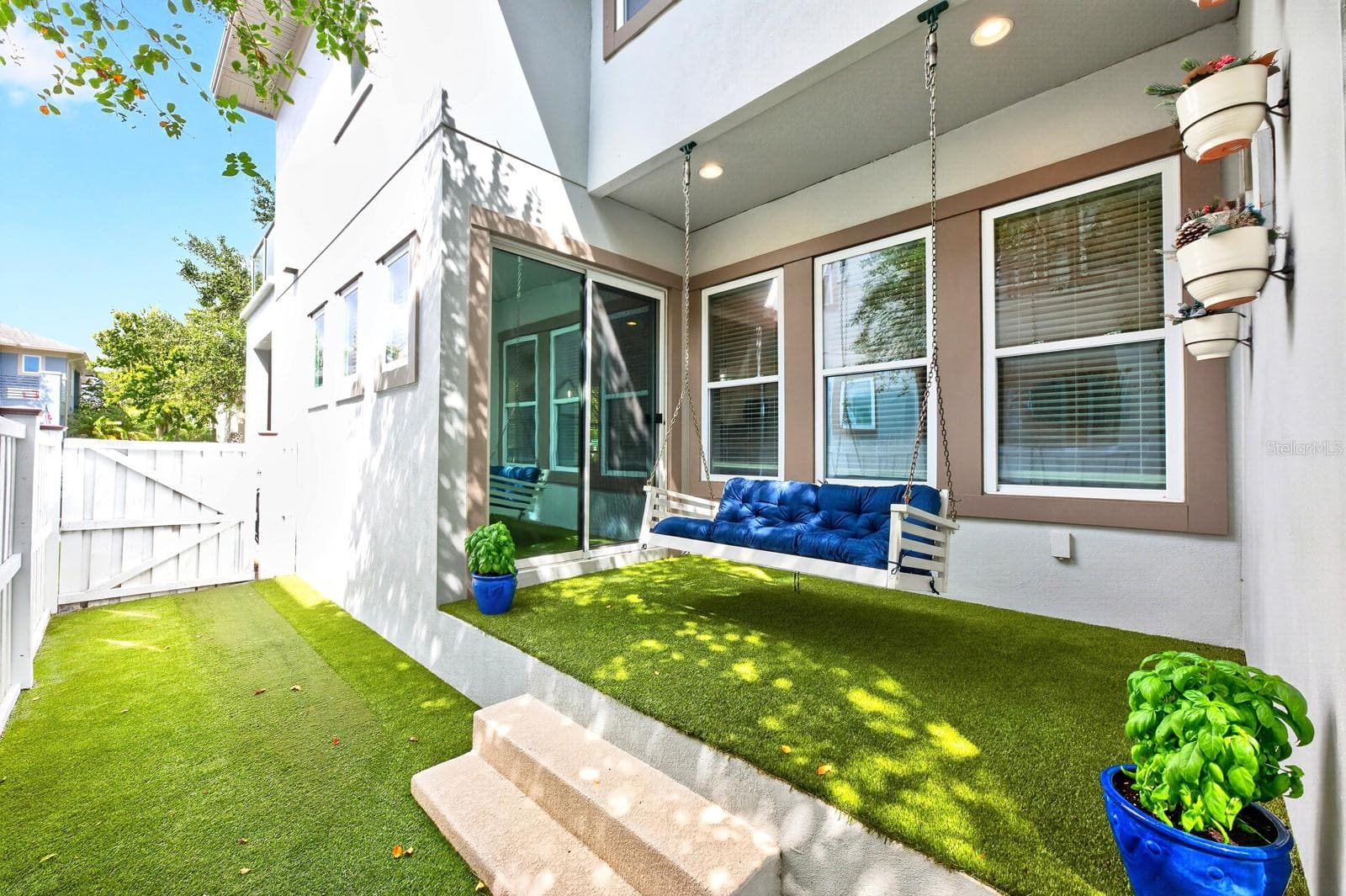 Low maintenance patio, privacy fenced sideyard finished with turf. - 14061 WALCOTT AVE, ORLANDO