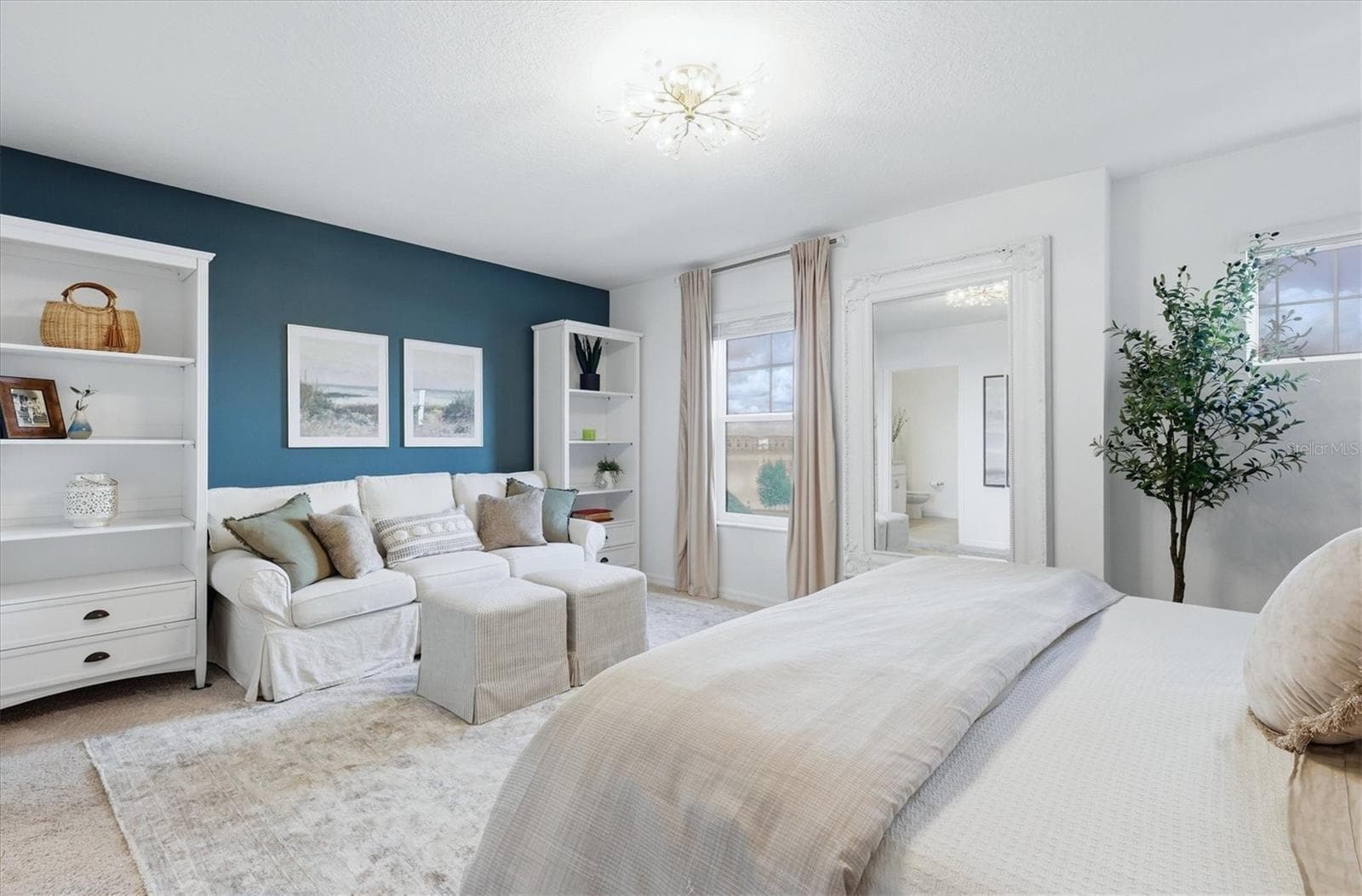 Primary bedroom with seating area and view of lake - 7392 CABIN LN, SARASOTA