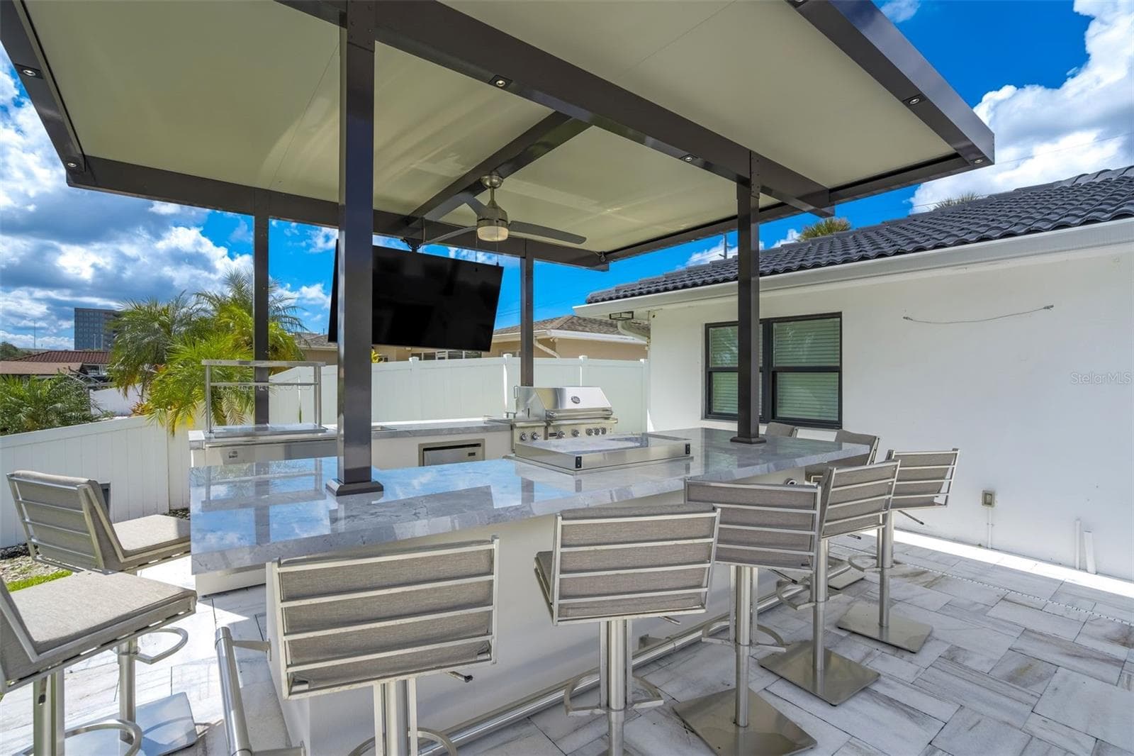 Outdoor kitchen with gas grill, griddle, multiple beverage coolers, and speaker system - 3923 DORAL DR, TAMPA
