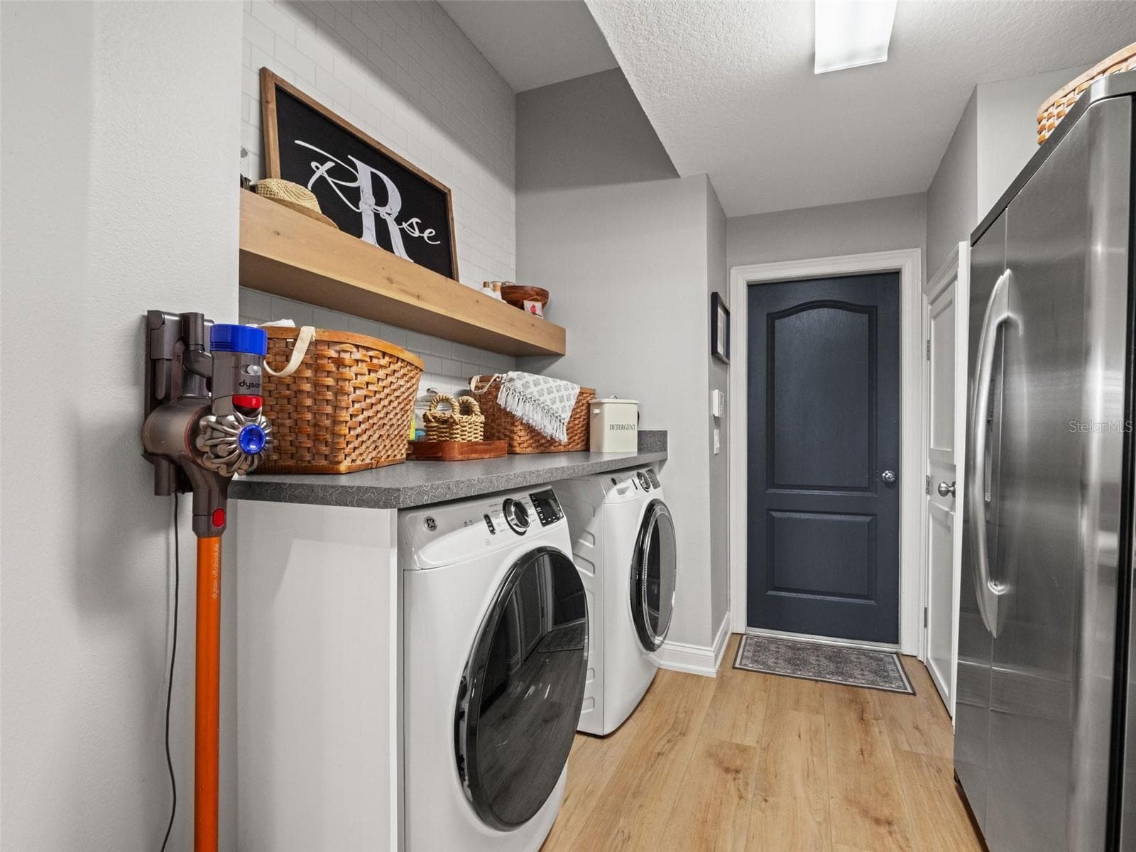 Barn doors lead to the laundry room with built in folding area - 25535 HAWKS RUN LN, SORRENTO
