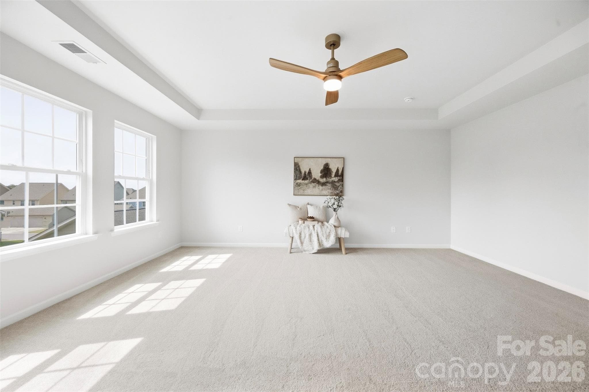 New ceiling fan adds a stylish and functional finishing touch to the primary suite - 2015 Kensley Drive, Waxhaw