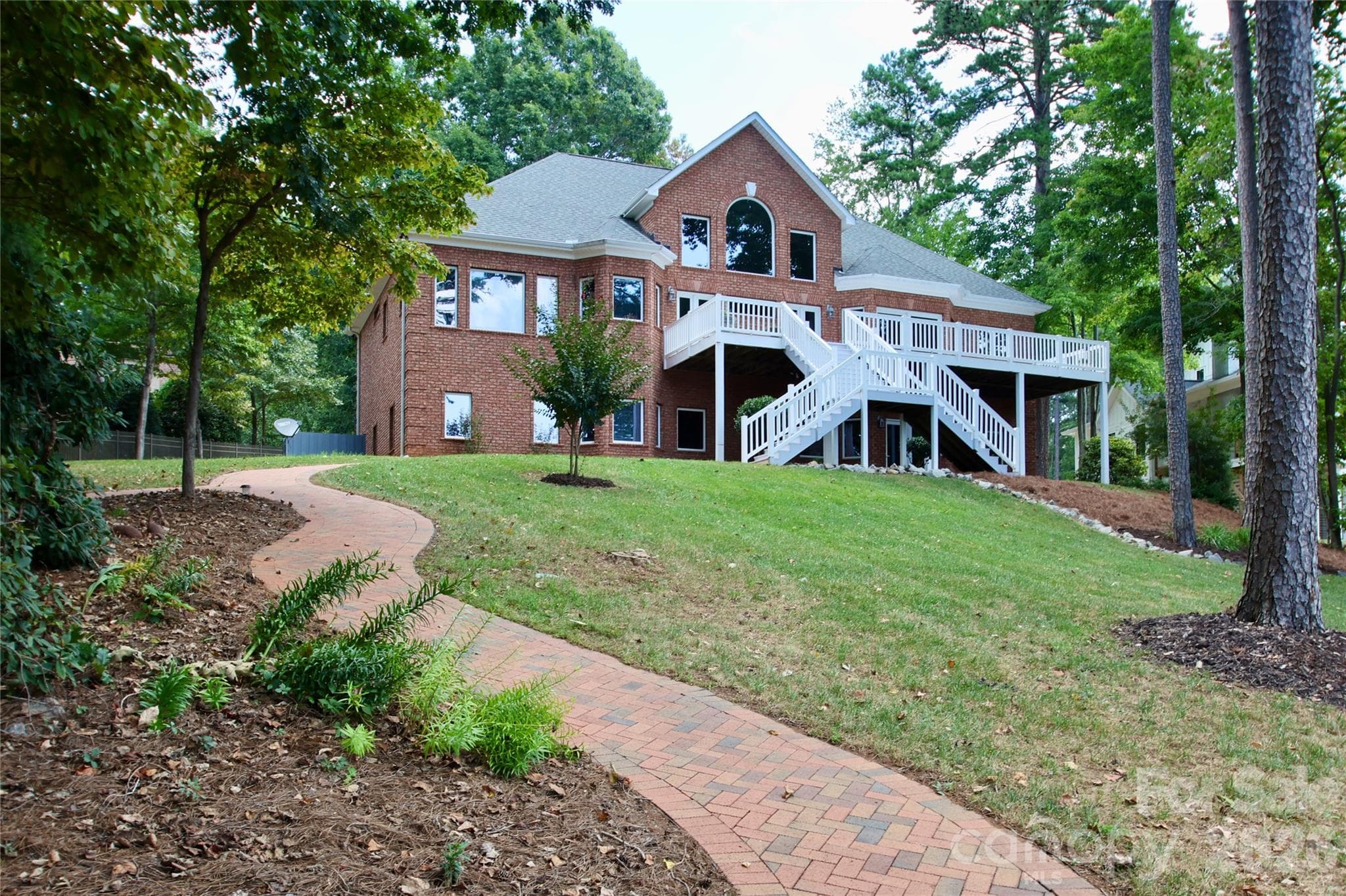 Statuesque view with the dual staircases leading down to the lake from the big back deck to entertain all your guests. - 140 Holt Lane, Mooresville