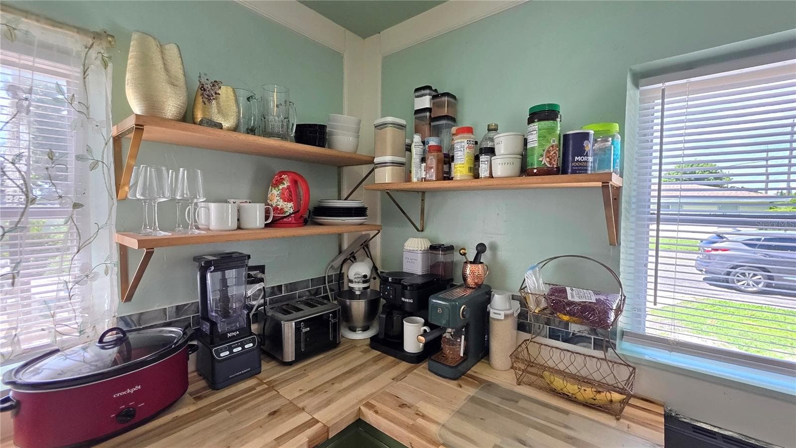 Corner View of Kitchen Counter, Shelving, and Windows - 1702 26TH ST W, BRADENTON