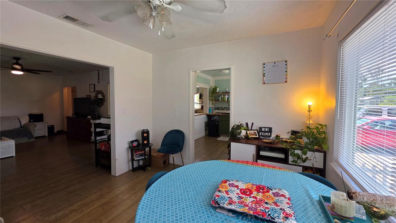 Dining/Flex Room Adjacent to Livingf Room, with Ceiling Fan, Laminate Flooring, and Windows overlooking Side Yard - 1702 26TH ST W, BRADENTON