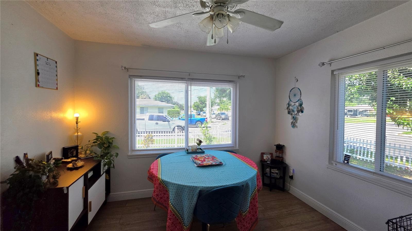 Dining/Flex Room with Ceiling Fan, Laminate Flooring, and Windows overlooking Side Yard and Front Yard - 1702 26TH ST W, BRADENTON