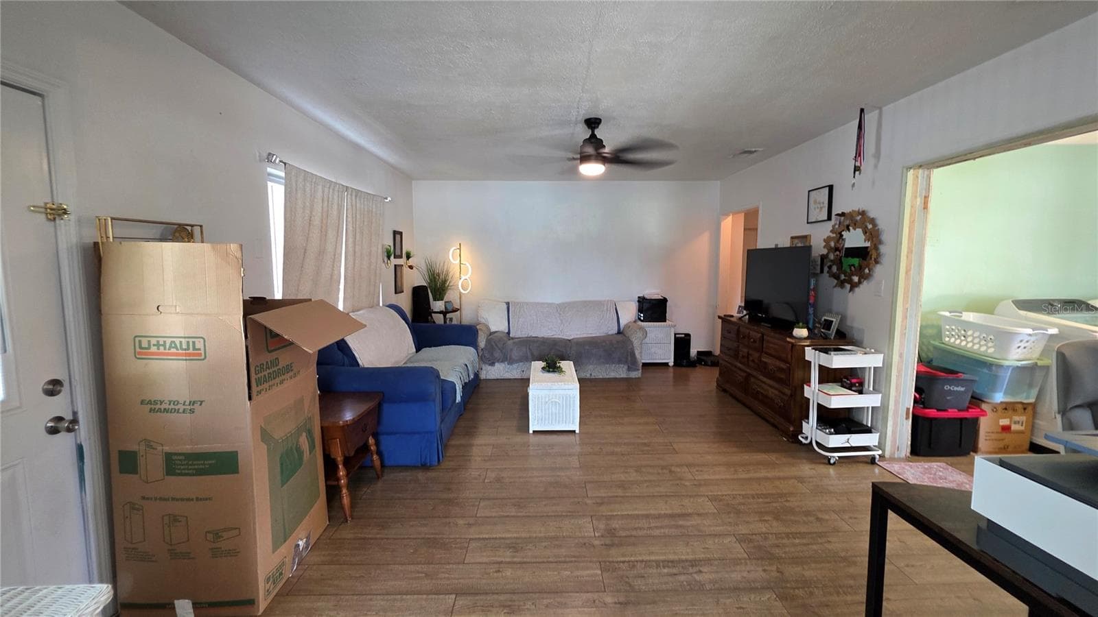 Living Room with Ceiling Fan, Laminate Flooring, and Window overlooking Front Yard - 1702 26TH ST W, BRADENTON