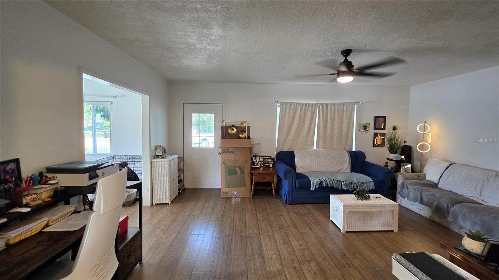 Living Room with Ceiling Fan, Laminate Flooring, and Window overlooking Front Yard, Front Door Entry - 1702 26TH ST W, BRADENTON