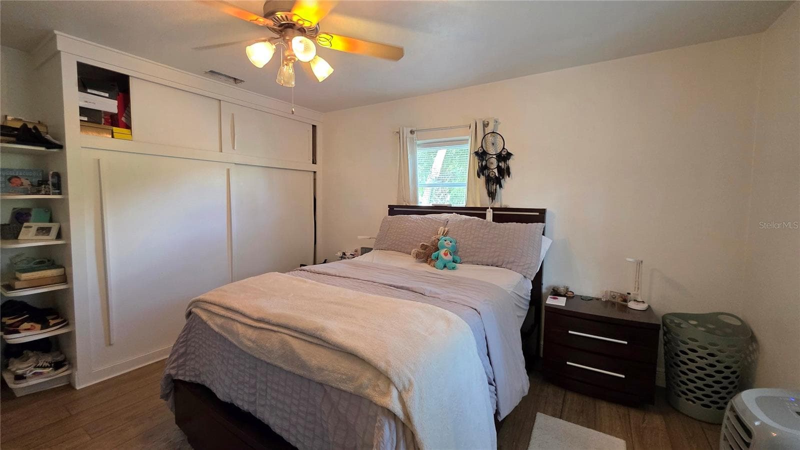 Primary Bedroom, Decorative Shelving, Ceiling Fan, Laminate Flooring, Window overlooking Front Yard - 1702 26TH ST W, BRADENTON