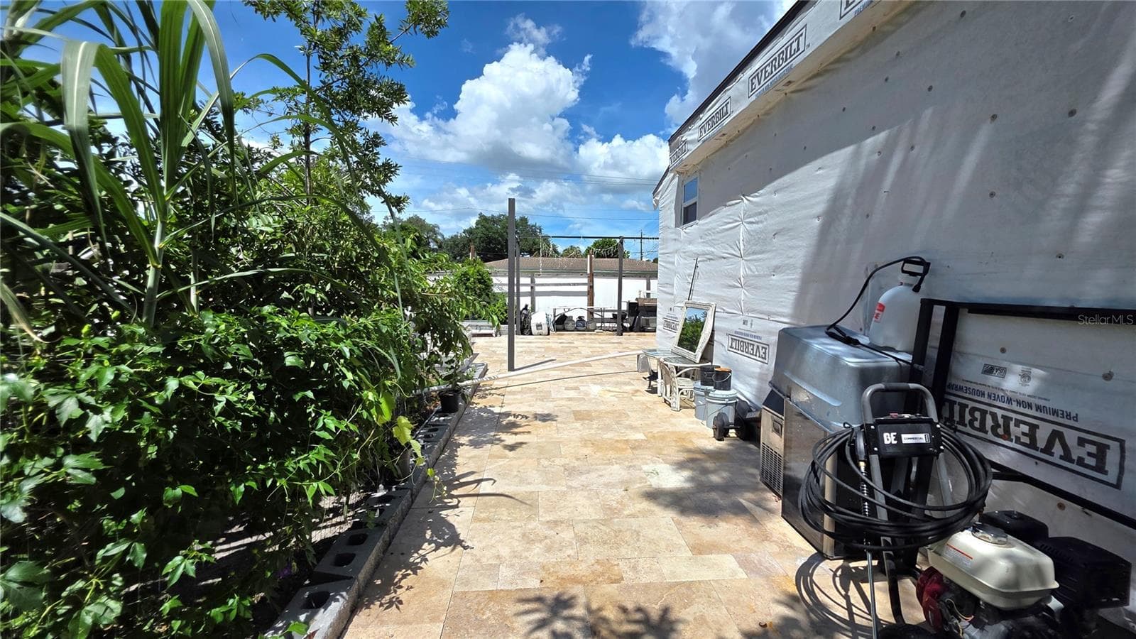 View from Behine Home, Garden Area, Tiled/Pavered Back Patio. Note - Addition being added to home will need to be removed. - 1702 26TH ST W, BRADENTON