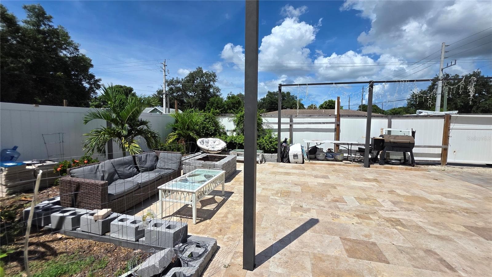 Pavered/Tiled back patio area with vinyl fence partition - 1702 26TH ST W, BRADENTON