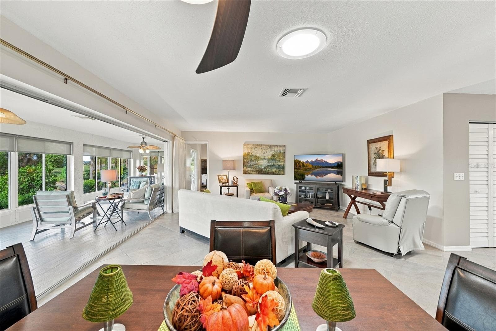 Multiple sliding glass doors offer a separation of space, if desired. - 211 STONEHAM DR, SUN CITY CENTER