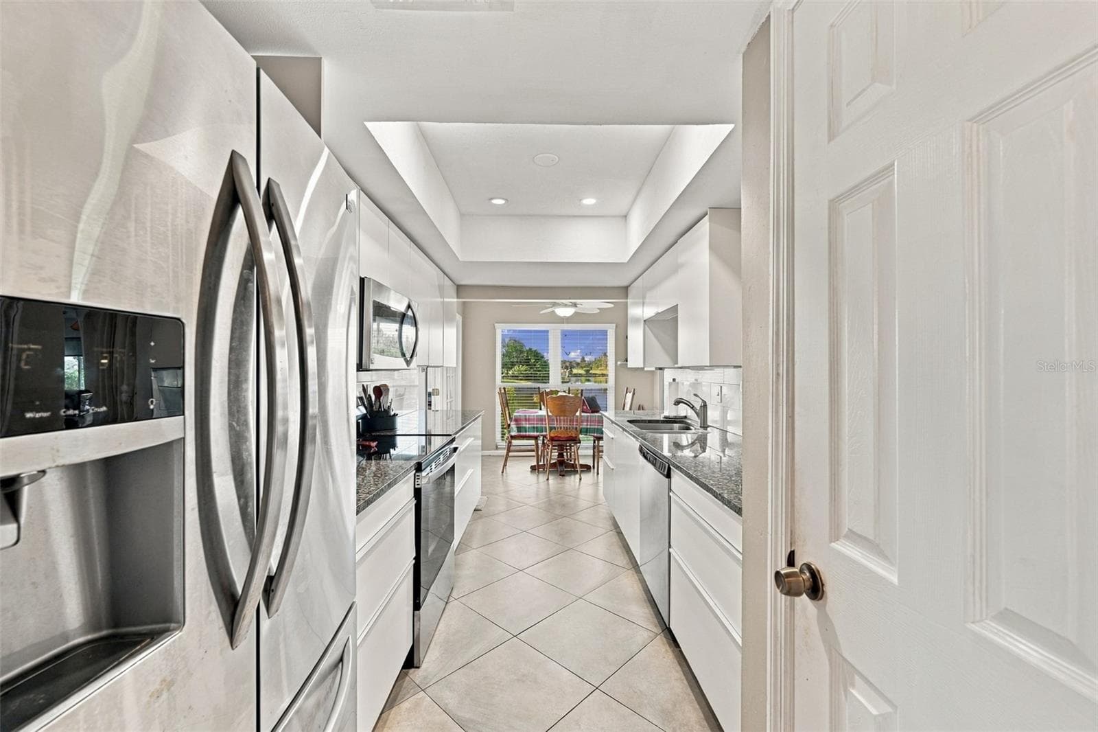 Kitchen offers lovely stainless steel appliances, lots of storage (including a pantry), granite counter tops and an exceptional view. - 211 STONEHAM DR, SUN CITY CENTER