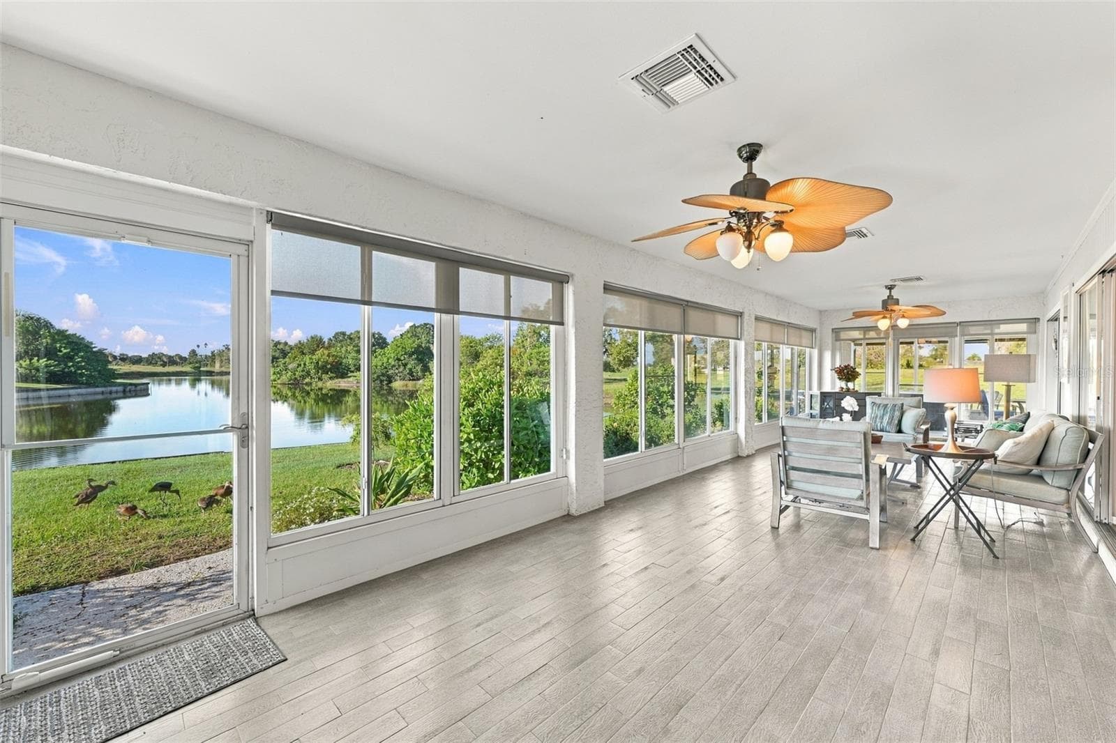 The Florida room is exceptional in size, light and comfort. Ducks, herons, fish, turtles and various other wild life are right out your back door. - 211 STONEHAM DR, SUN CITY CENTER