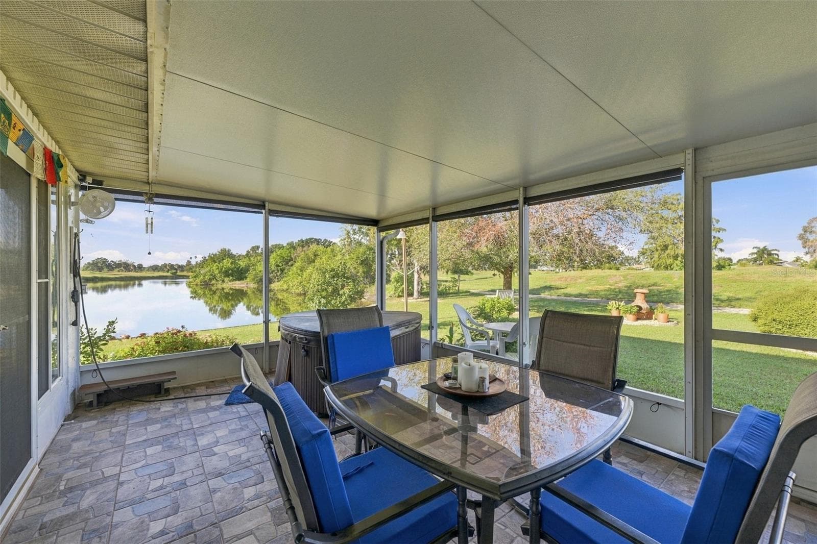 Next to the Florida room is the first screened in area, which also includes a fully functioning HOT TUB, oscolating fans and a grill! - 211 STONEHAM DR, SUN CITY CENTER