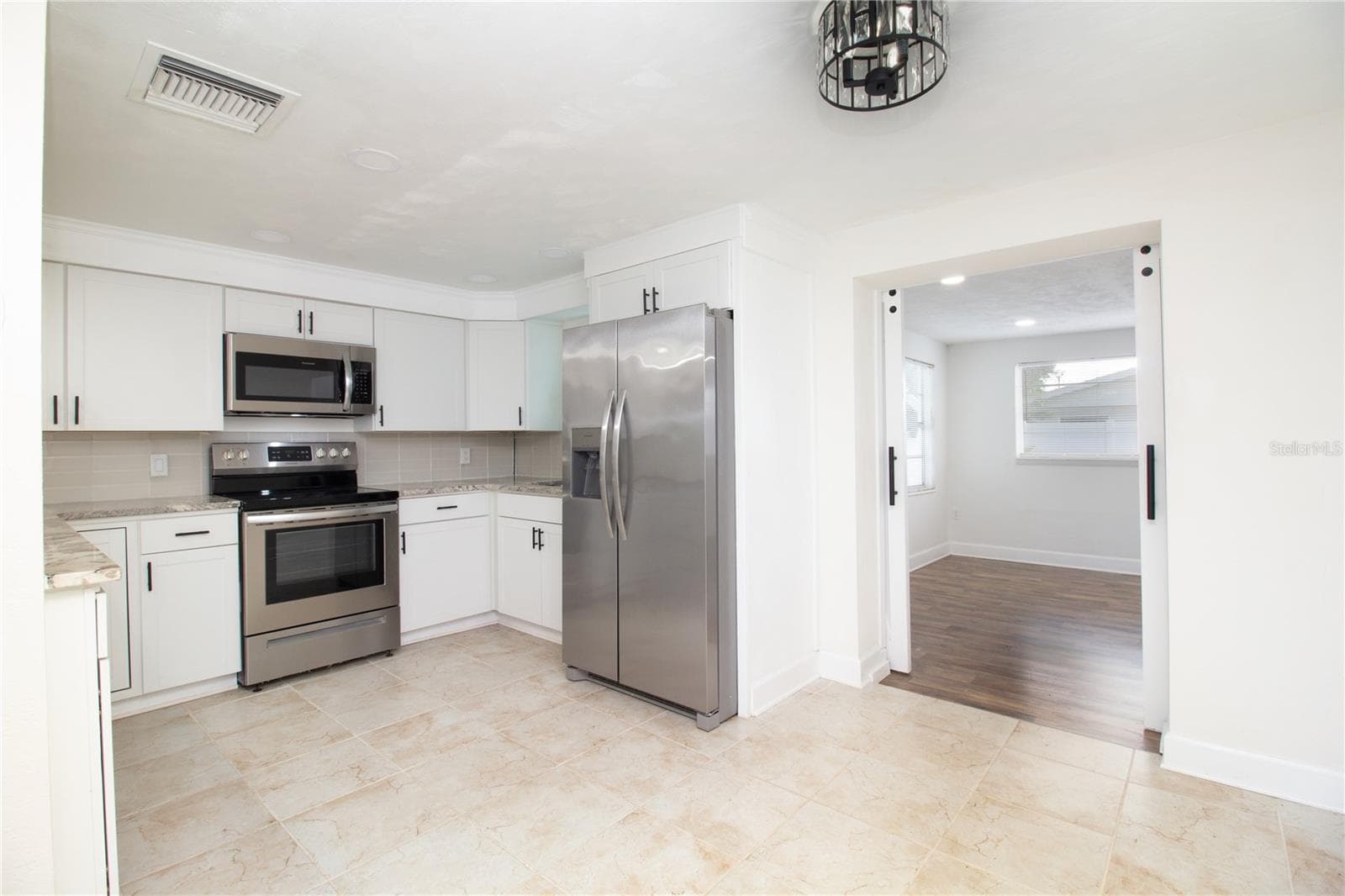 Kitchen and Primary bedroom in the backround - 1408 JENNINGS DR, HOLIDAY