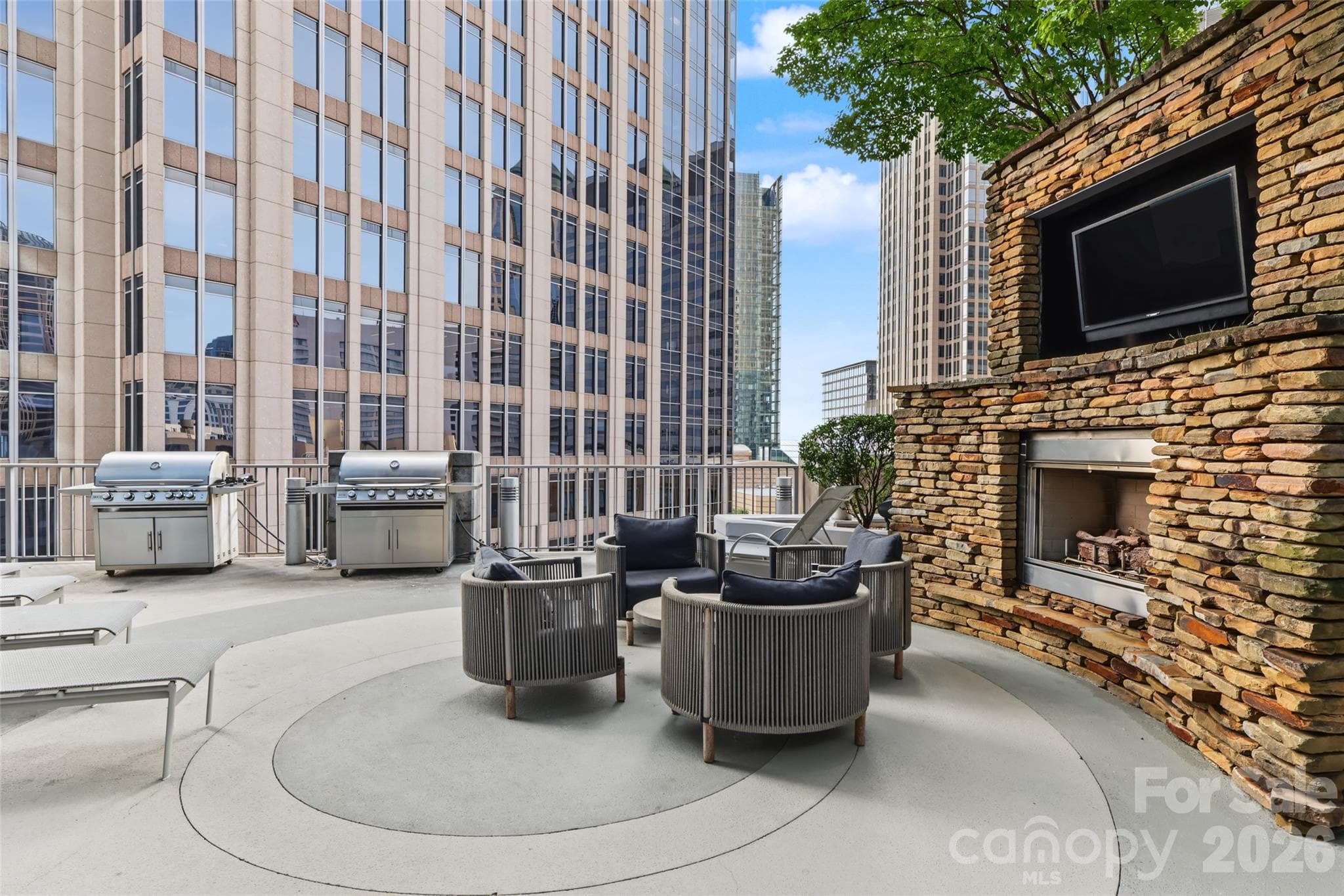 Community outdoor lounge area with a fireplace - 210 N Church Street, Charlotte