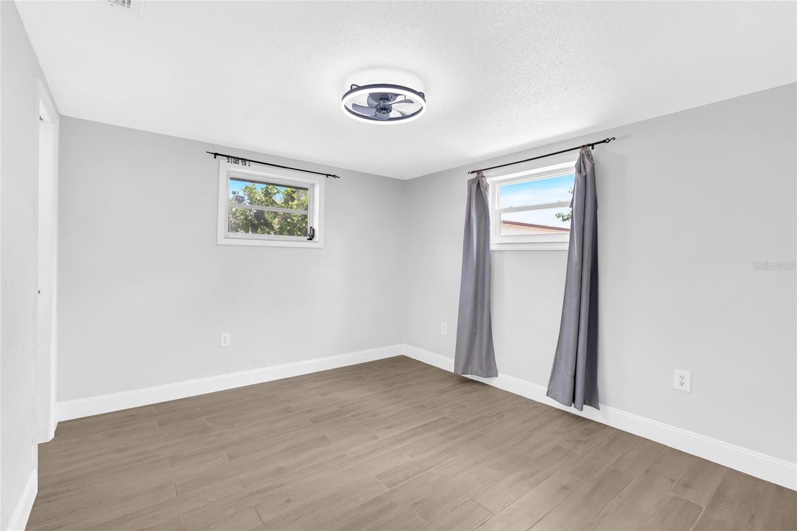 The primary bedroom offers generous proportions, updated flooring and the privacy of its own ensuite bath and walk in closet. - 142 2ND AVE, NOKOMIS