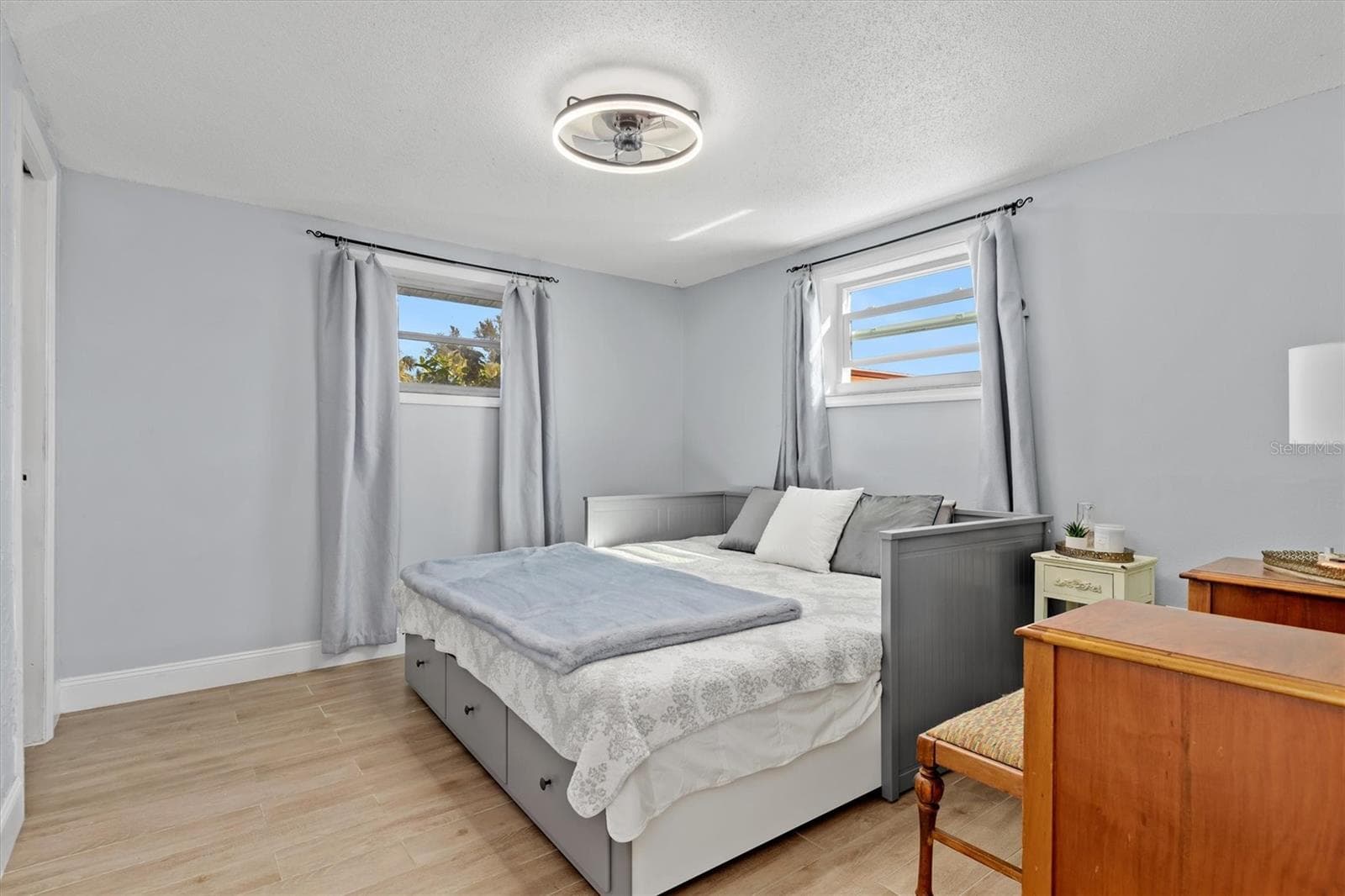 Spacious primary suite with room for a king size bed and additional furnishings, plus a walk in closet and private ensuite bath. Photo taken during prior occupancy. - 142 2ND AVE, NOKOMIS