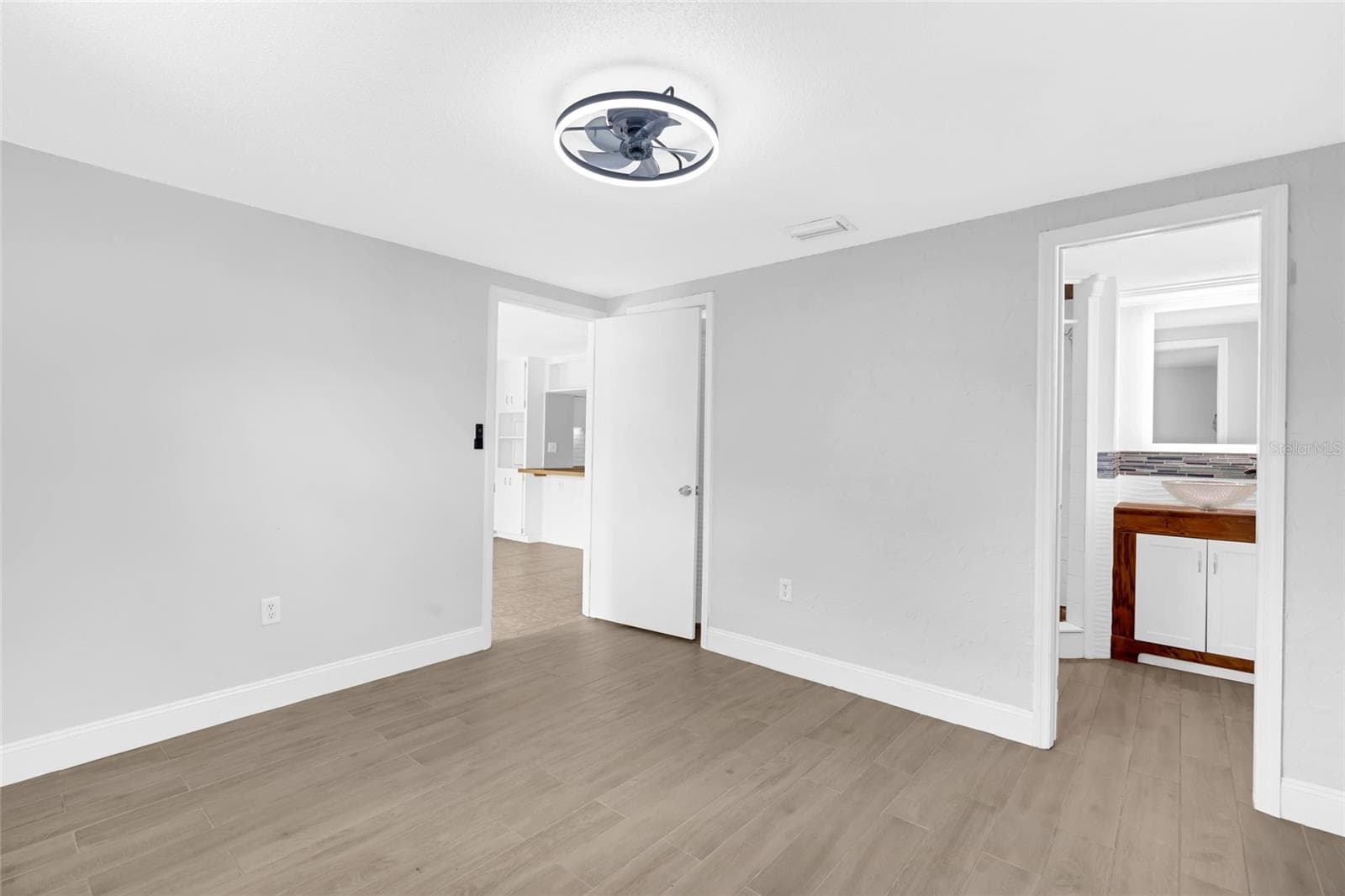 The updated primary bath features a walk in shower, vessel sink and distinctive tile work that gives the space personality. - 142 2ND AVE, NOKOMIS