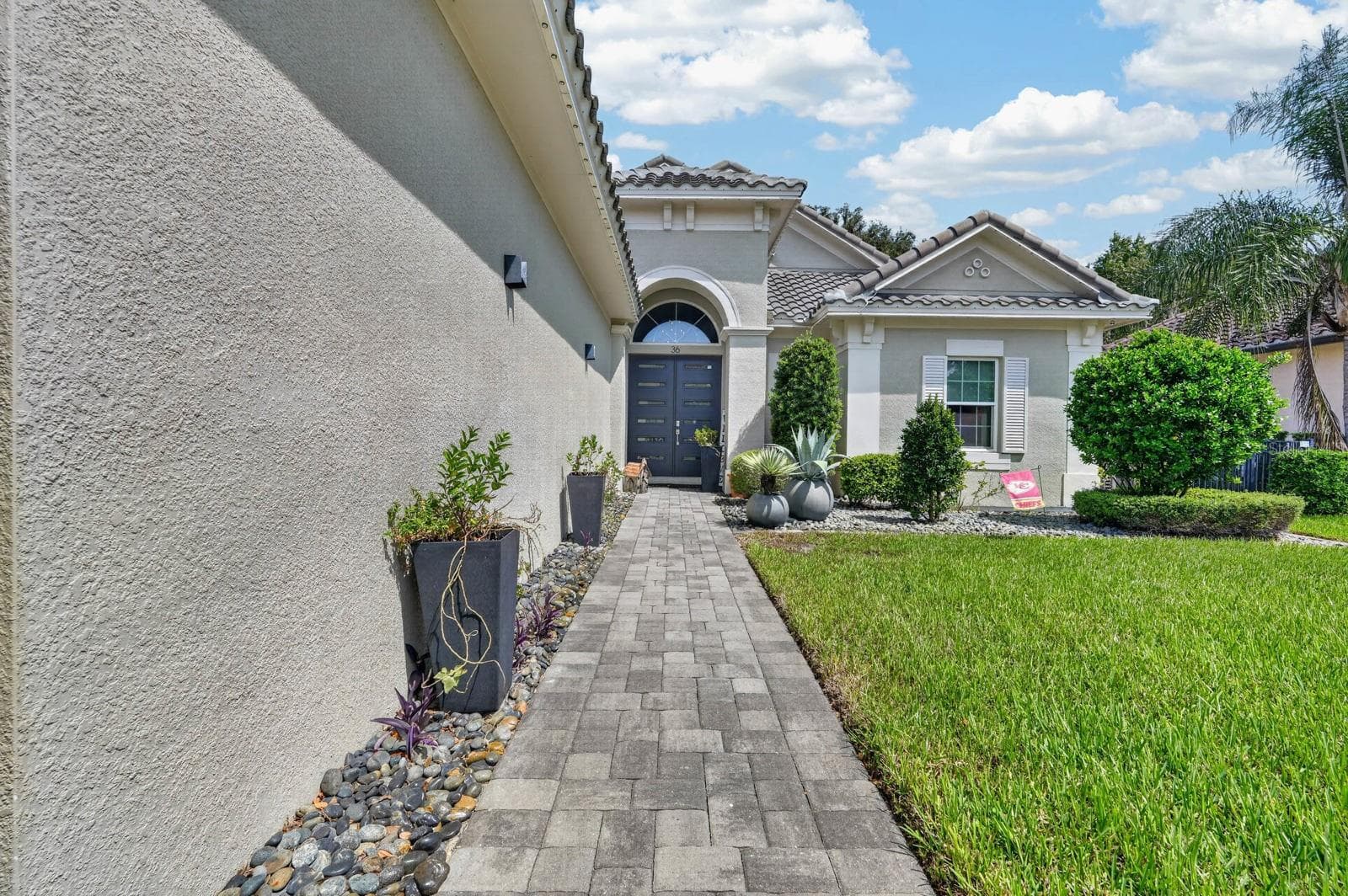 long paver sidewalk up to beautiful double door entry - 36 NEW WATER OAK DR, PALM COAST