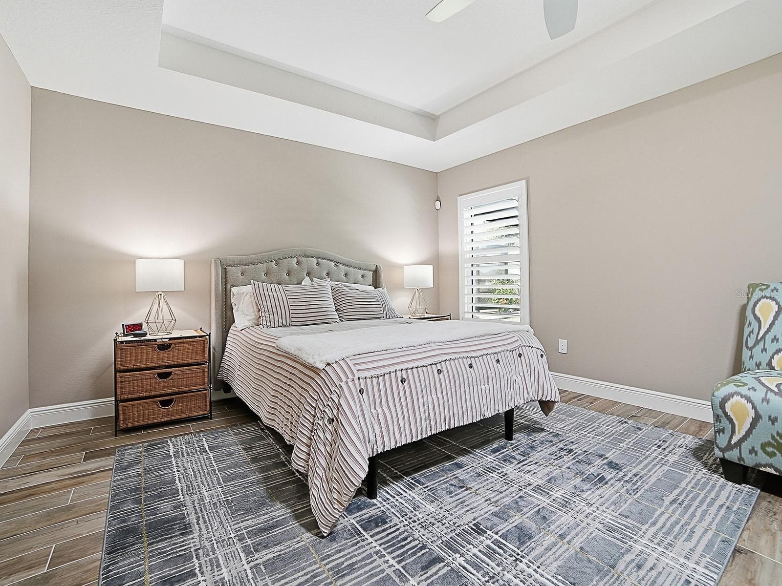 PRIMARY BEDROOM WITH TRAY CEILING AND PLANTATION SHUTTERS. - 3075 LICCIARDELLO PATH, THE VILLAGES