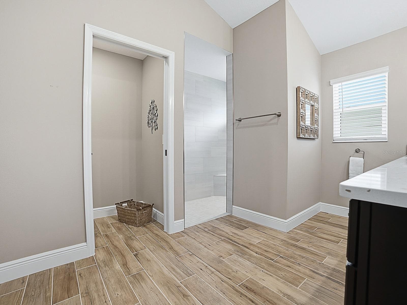 POCKET DOOR TO THE PRIVATE TOILET ROOM AND ROMAN WALK-IN SHOWER TO THE RIGHT. - 3075 LICCIARDELLO PATH, THE VILLAGES