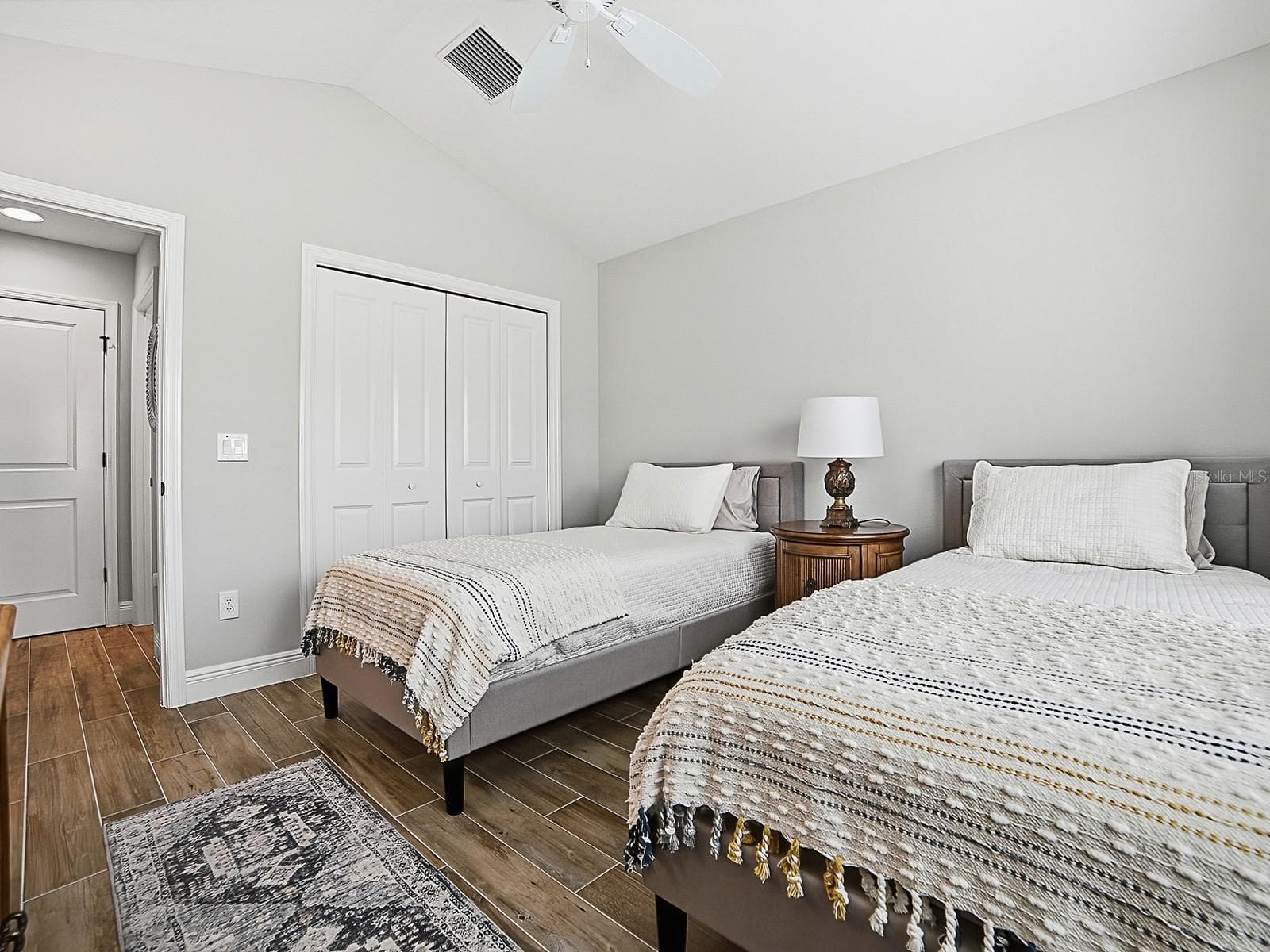THIS GUEST SUITE IS TO THE RIGHT OF THE FOYER WHEN YOU ENTER THE HOME. VAULTED CEILINGS AND DOUBLE DOOR CLOSET. LINEN CLOSET IN THE HALLWAY AND TO THE RIGHT IS THE GUEST BATH. - 3075 LICCIARDELLO PATH, THE VILLAGES
