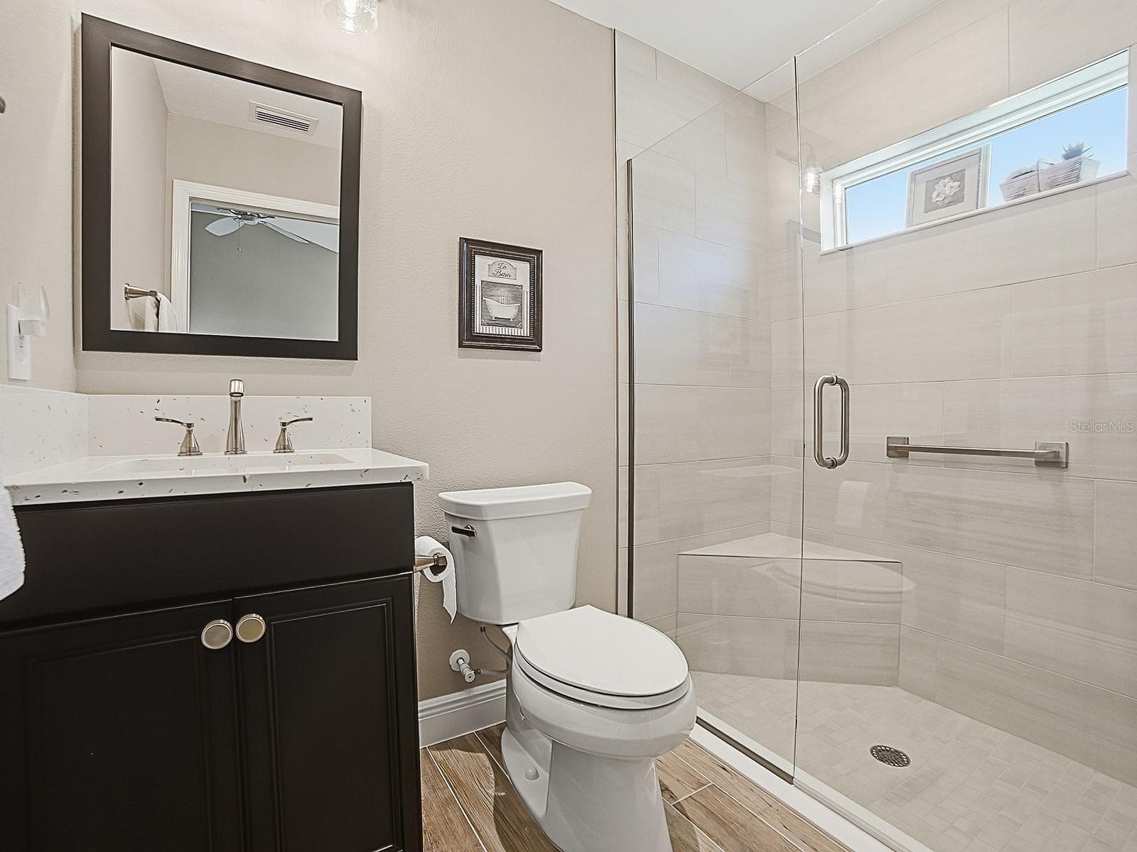 GUEST BATH WITH QUARTZ COUNTERTOPS AND FRAMELESS GLASS SHOWER DOOR. - 3075 LICCIARDELLO PATH, THE VILLAGES