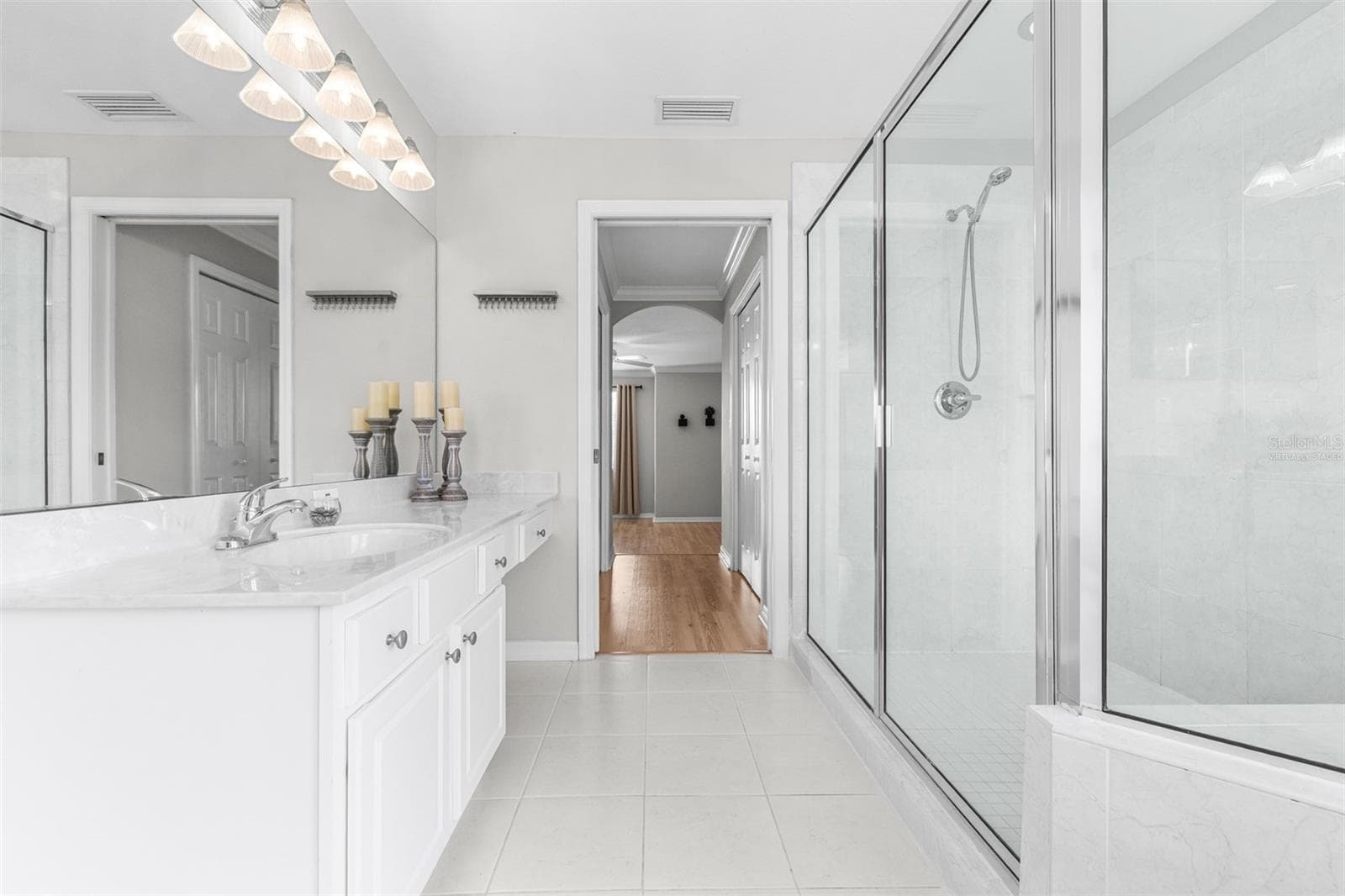 Primary bathroom with dual closets at entrance - 27015 FIREBUSH DR, WESLEY CHAPEL