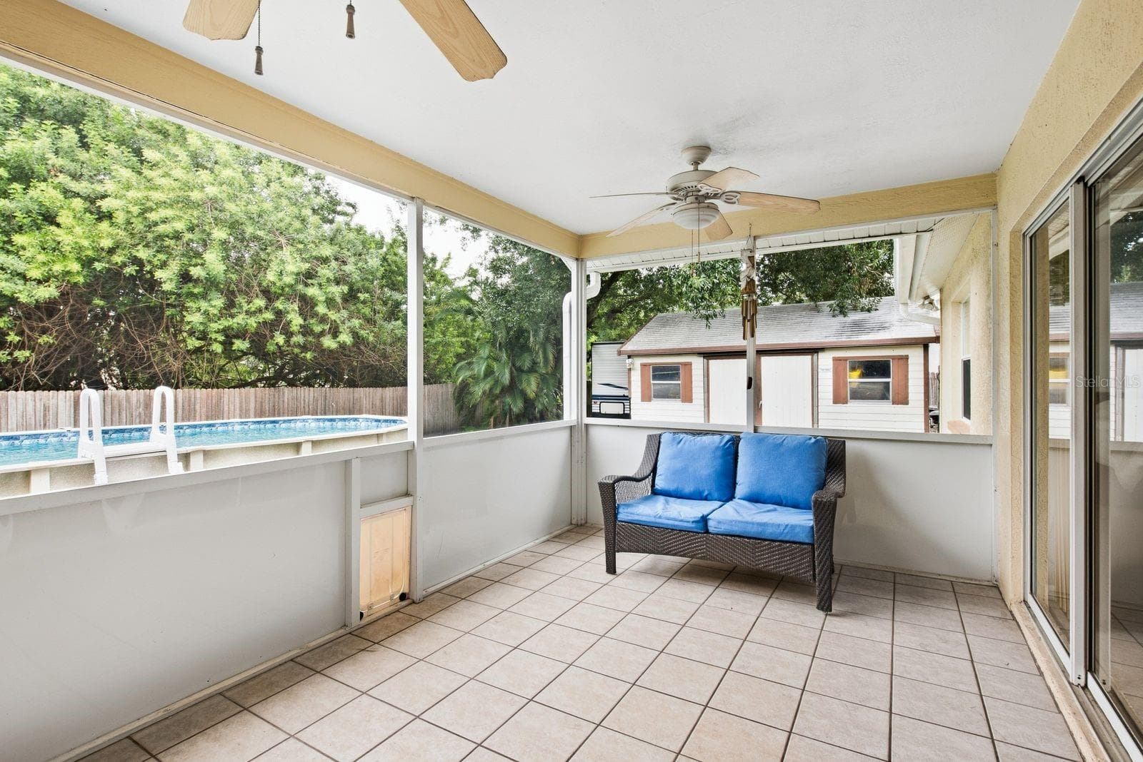 Back patio, leading to pool and backyard - 5955 107TH TER N, PINELLAS PARK
