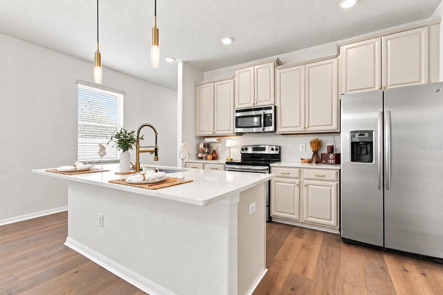 Updated kitchen with quartz island. - 18928 HAMPSTEAD HEATH CT, LAND O LAKES