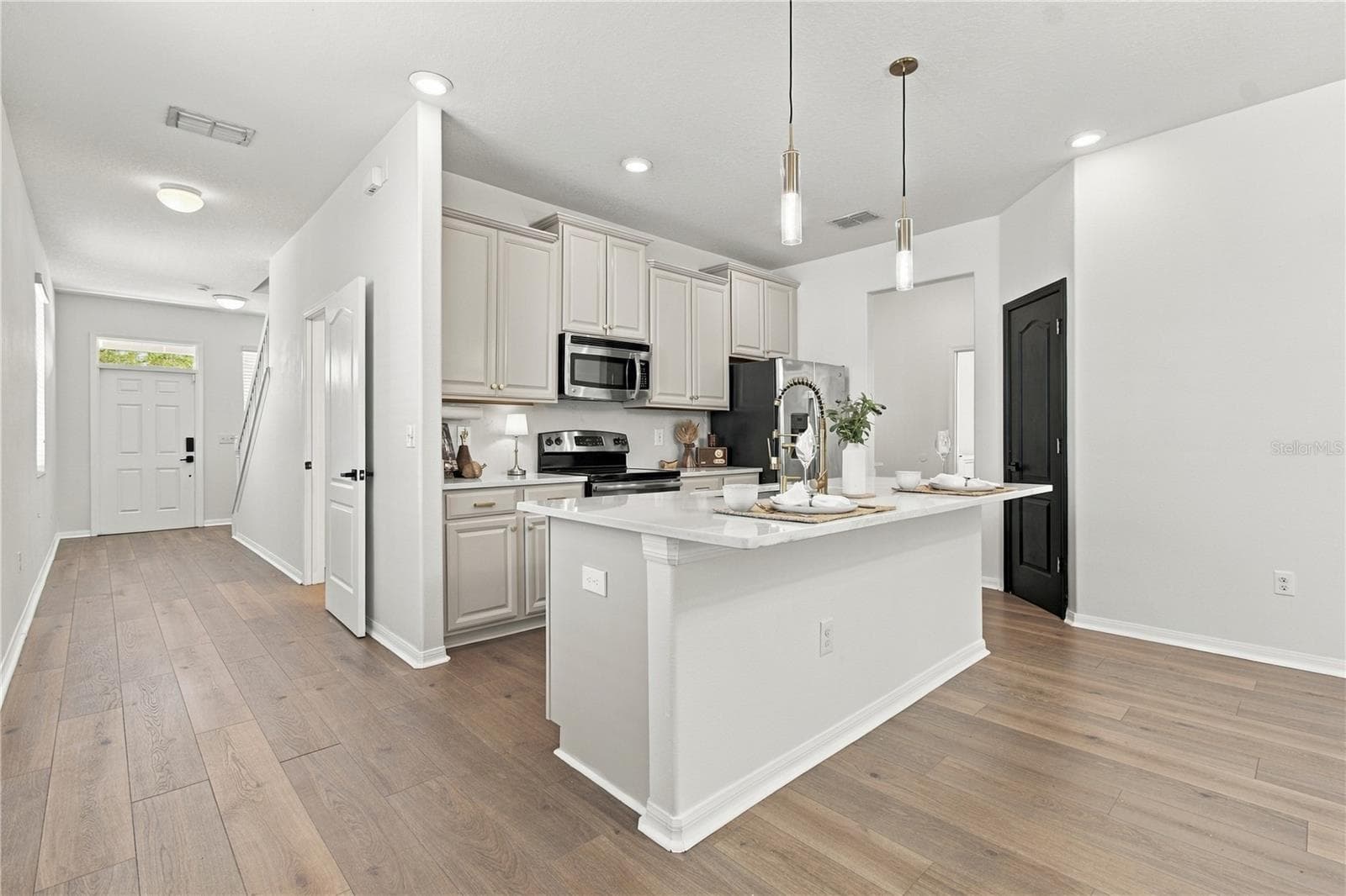 Kitchen to Hallway and Staircase - 18928 HAMPSTEAD HEATH CT, LAND O LAKES