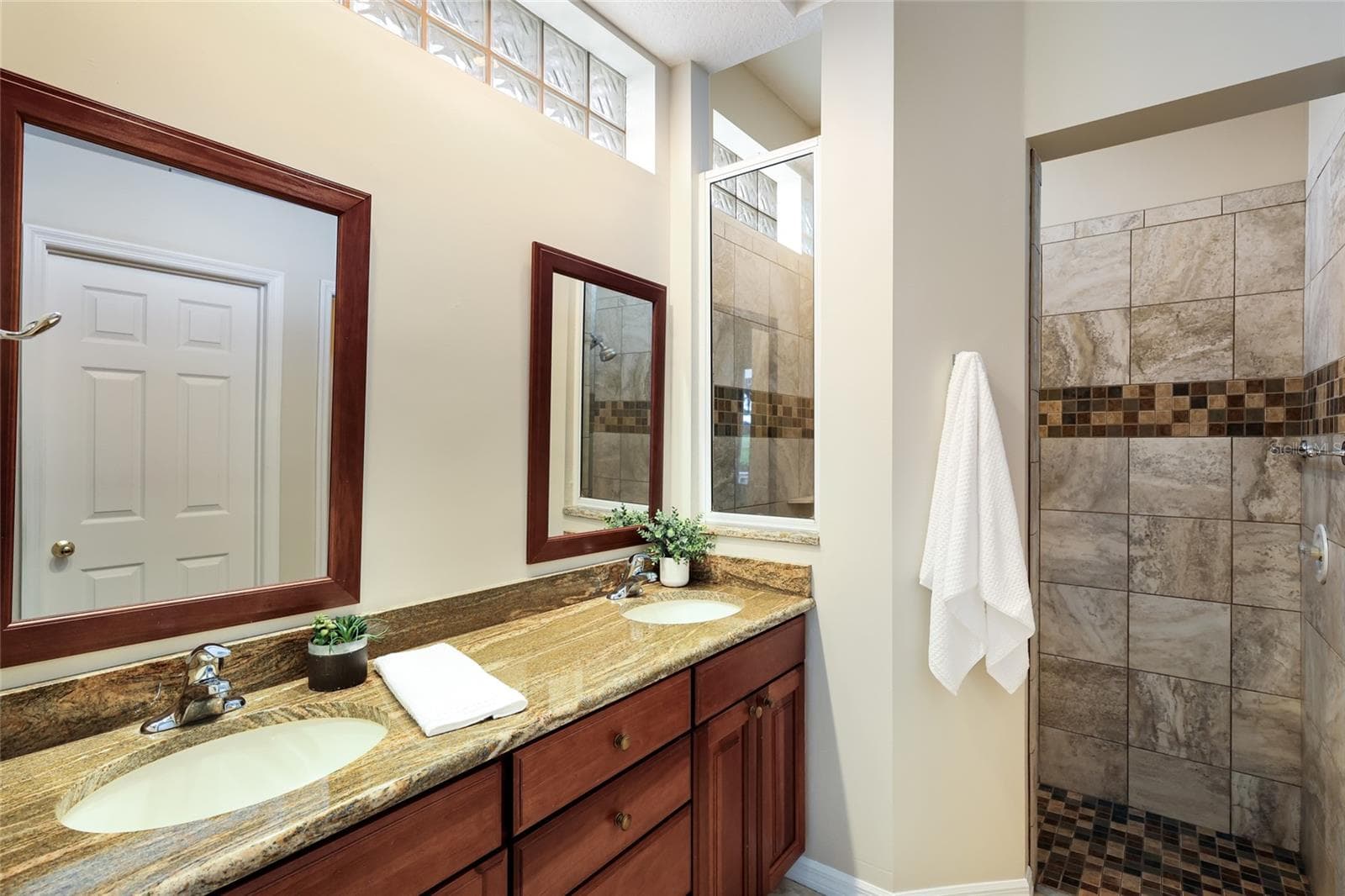 Ensuite bathroom with dual sink vanity, walk-in tile shower, private water closet and sizable walk-in closet - 8728 52ND DR E, BRADENTON