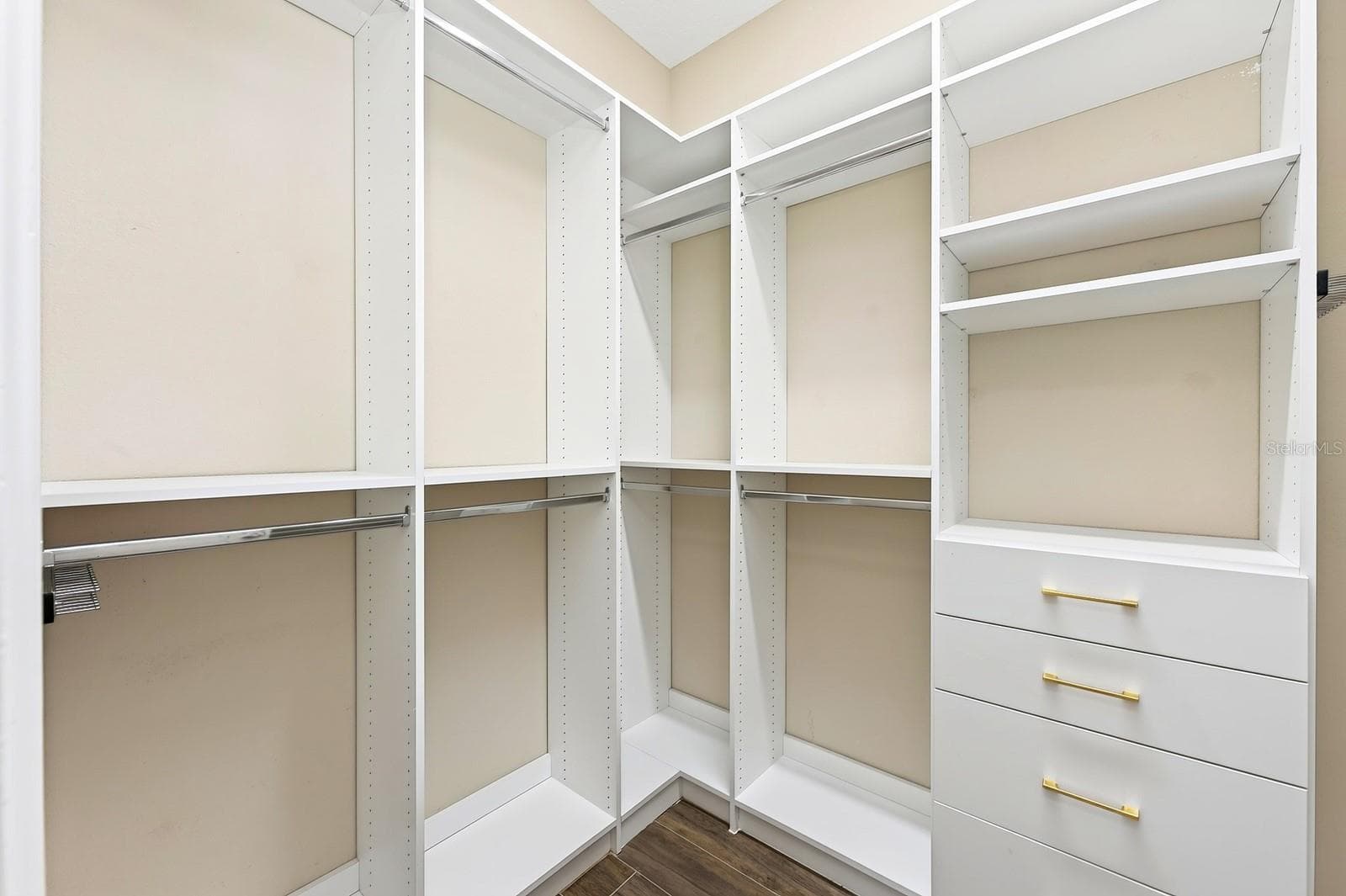 Primary suite walk-in closet with custom storage. - 9024 NEHER ST, ORLANDO