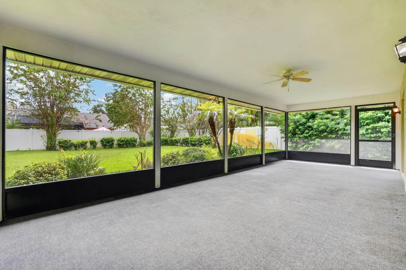 large covered and screened lanai looks out over the peaceful landscape - 156 BRESSLER LN, PALM COAST
