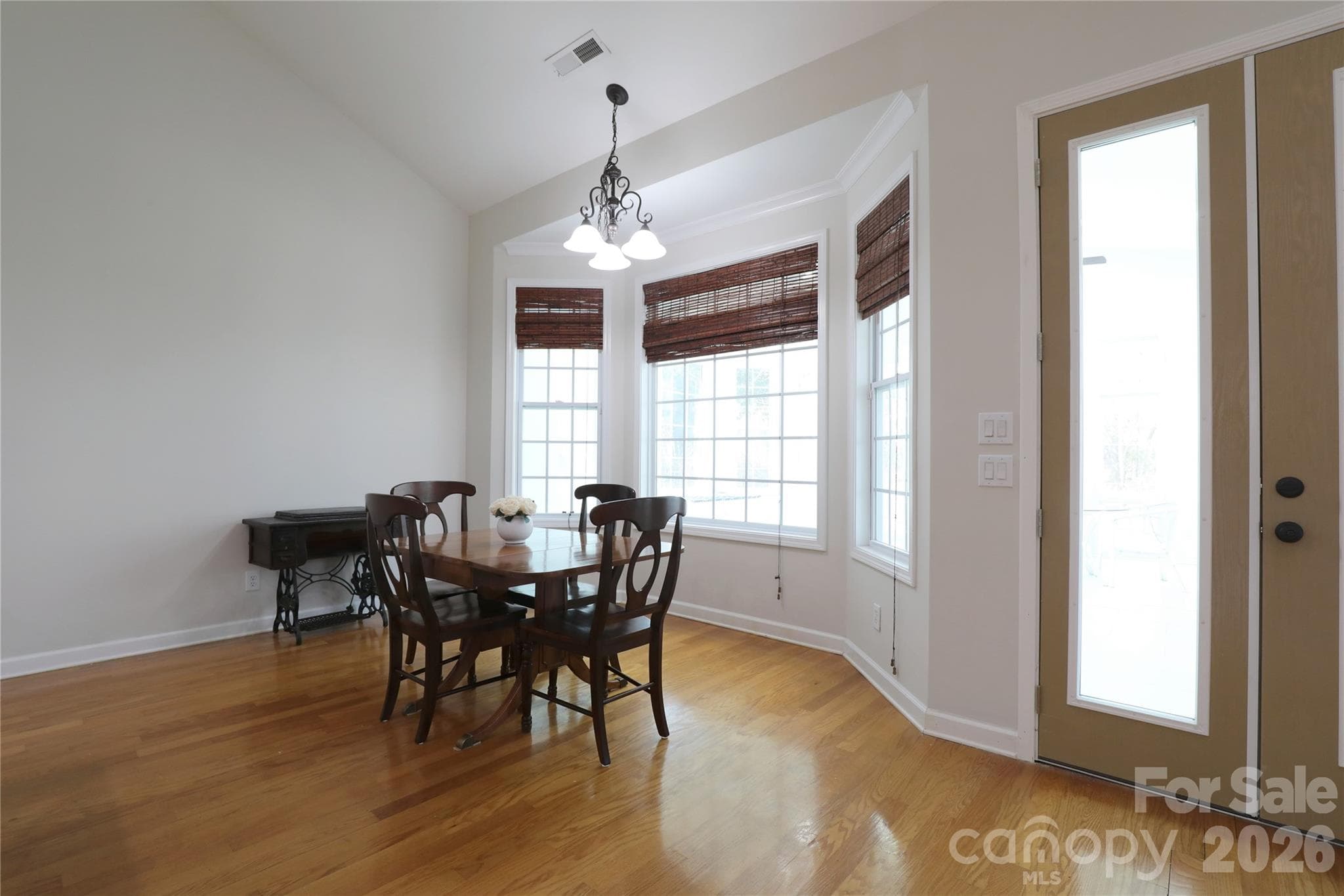 Breakfast area with vaulted ceiling overlooks sunroom - 18465 E Marbella Lane, Fort Mill