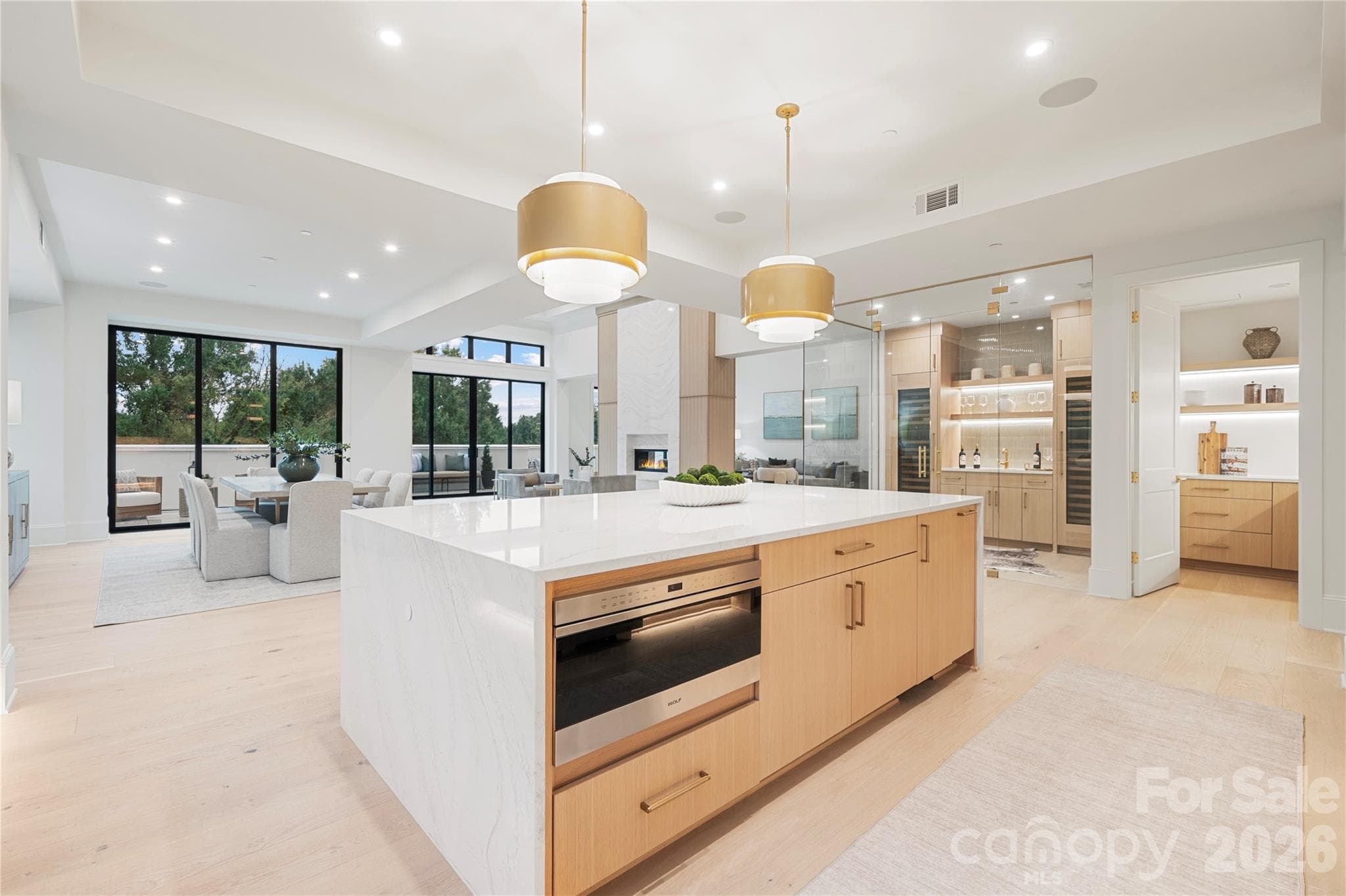The kitchen overlooks the family area, fireplace and terrace. And adjoining the kitchen is the glass-enclosed wine room and separate pantry, combining sophisticated design with exceptional function. - 409 Queens Road, Charlotte