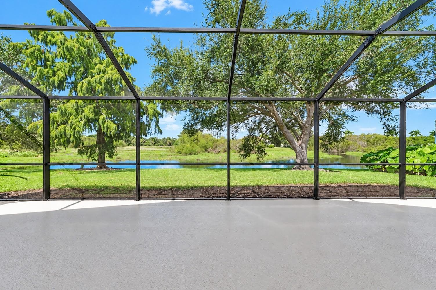 Lake and nature preserve view from large extended lanai. - 5113 FLAGSTONE DR, SARASOTA