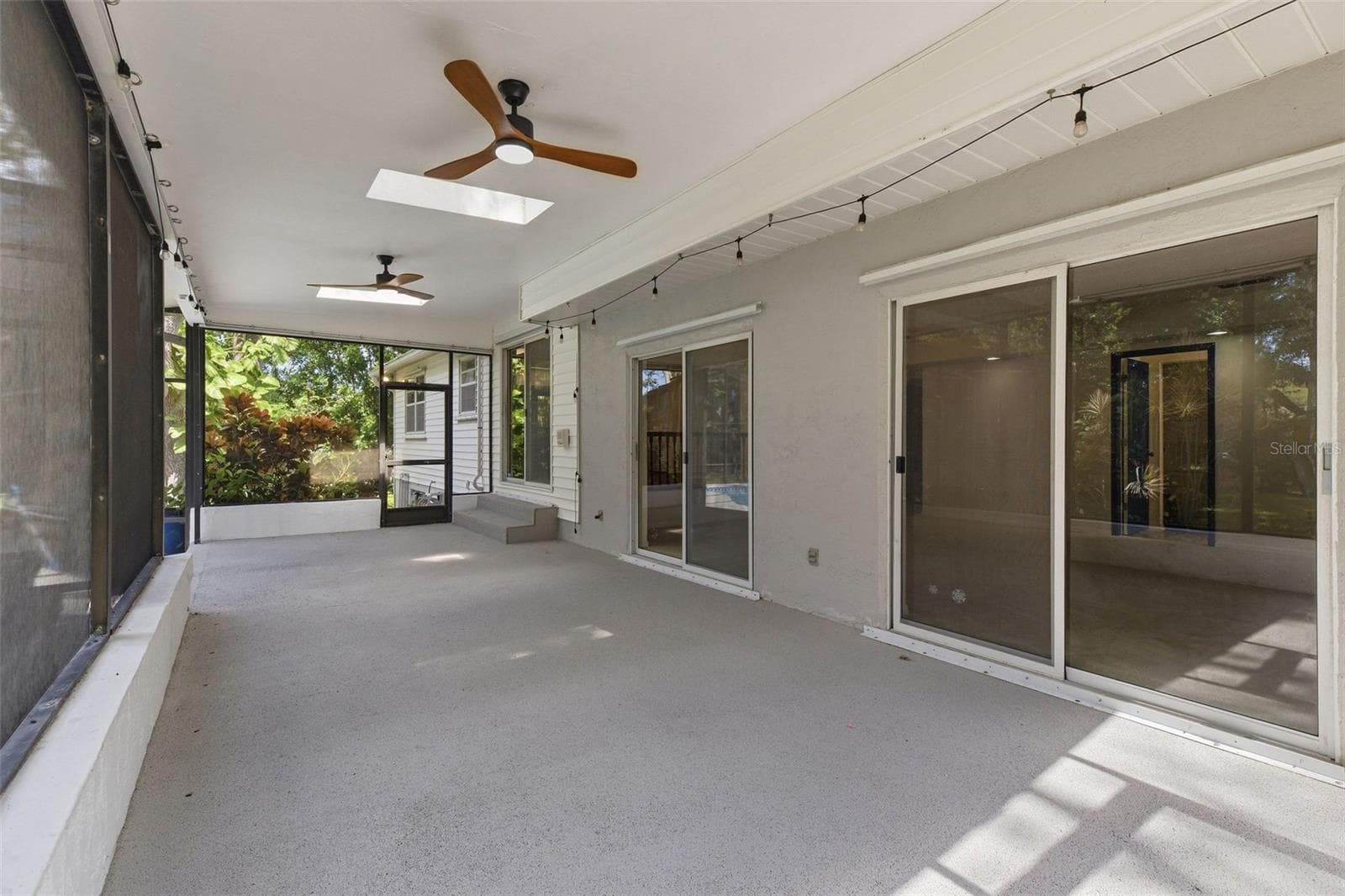 covered patio to pool - 1304 TREETOP DR, PALM HARBOR