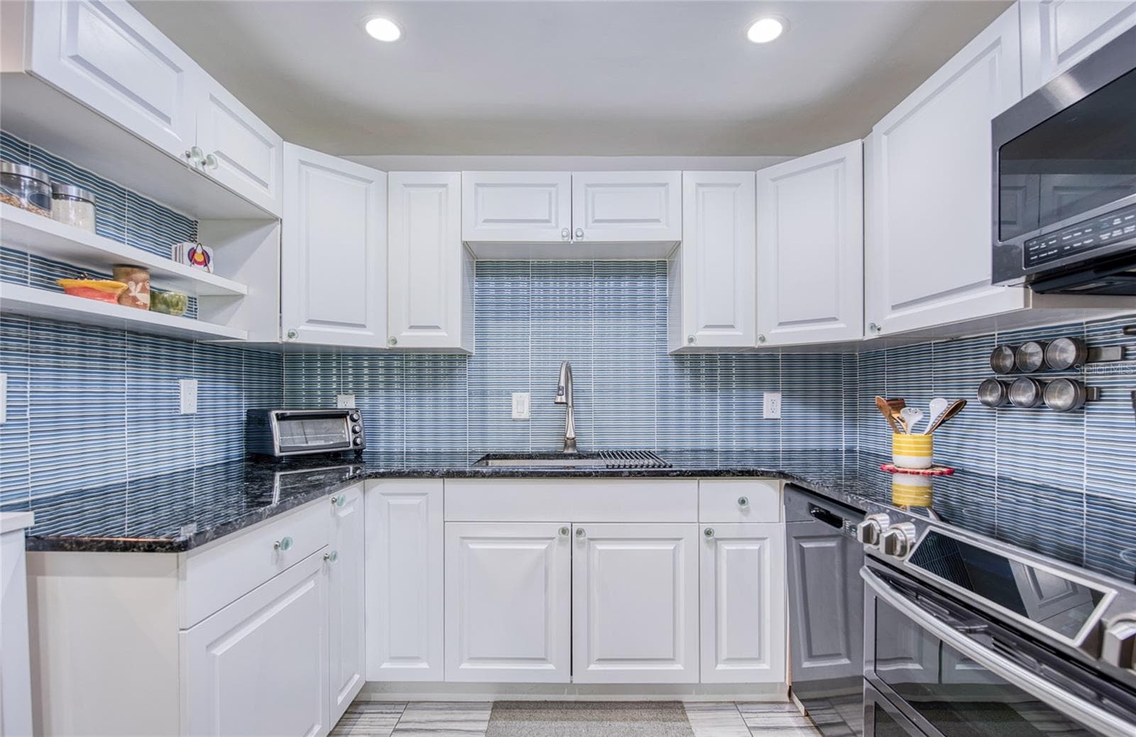 fully equiped kitchan with beautiful glass tile backsplash and newer stainless steel appliances. - 4681 1ST ST NE #301, ST PETERSBURG