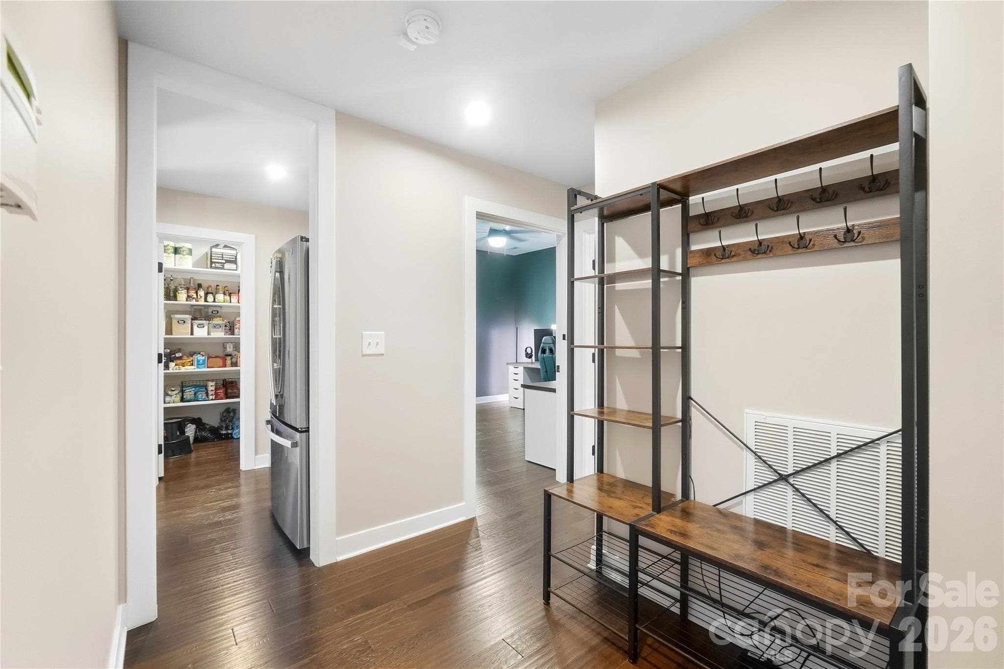 Mudroom off the garage entry, with a second refrigerator that conveys and direct access to the walk-in pantry and the study. - 912 Manorwood Drive, Waxhaw