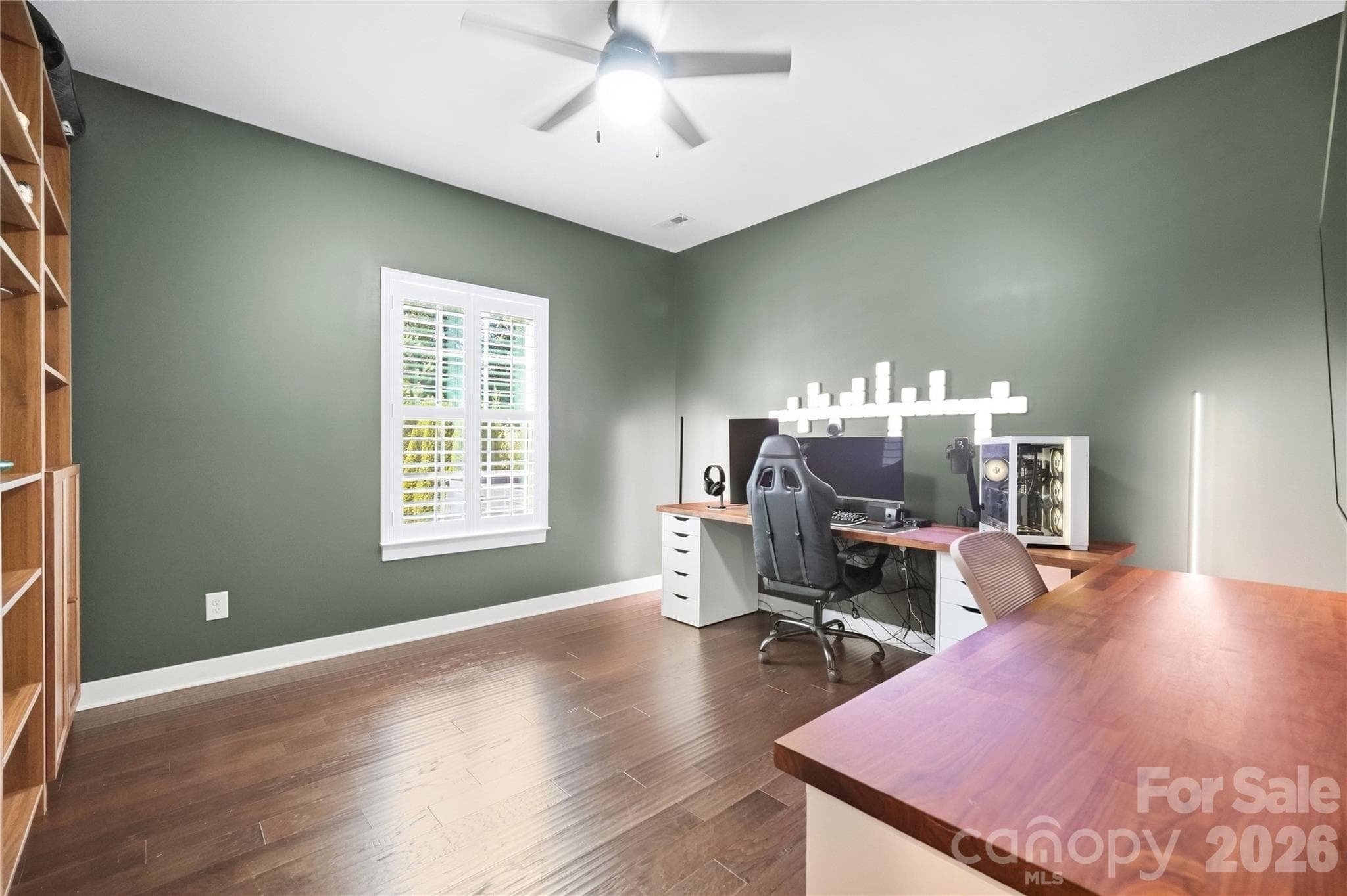 Flexible main-level study with plantation shutters and a ceiling fan, ready to work as a second home office, guest space, or workout room. - 912 Manorwood Drive, Waxhaw