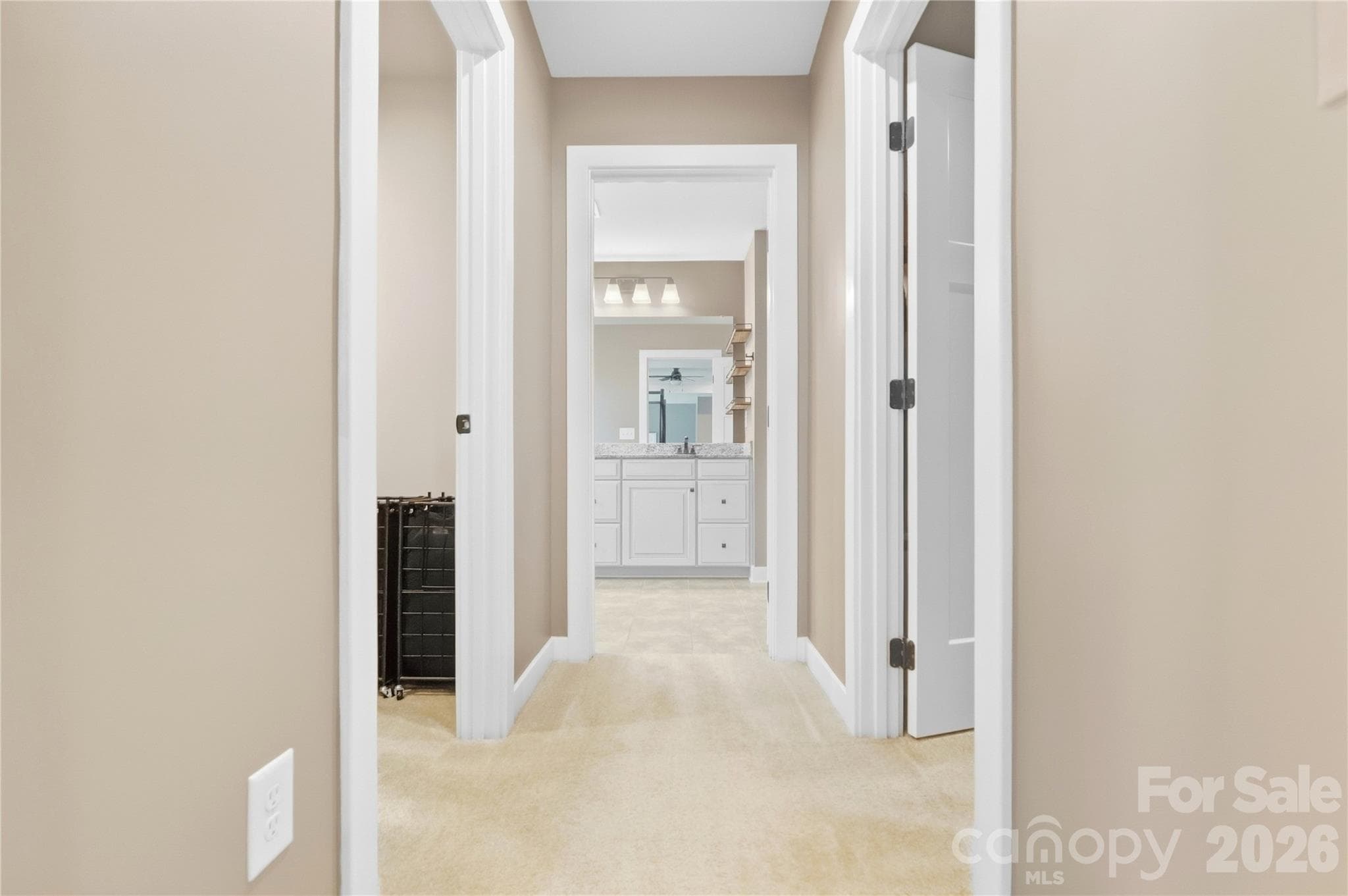 Two walk-in closets line the passage from the primary bedroom to the primary bath. - 912 Manorwood Drive, Waxhaw