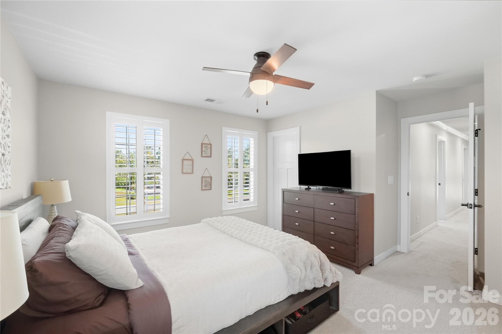 Bedroom 4 sits at the end of the hallway and has a walk-in closet. - 912 Manorwood Drive, Waxhaw
